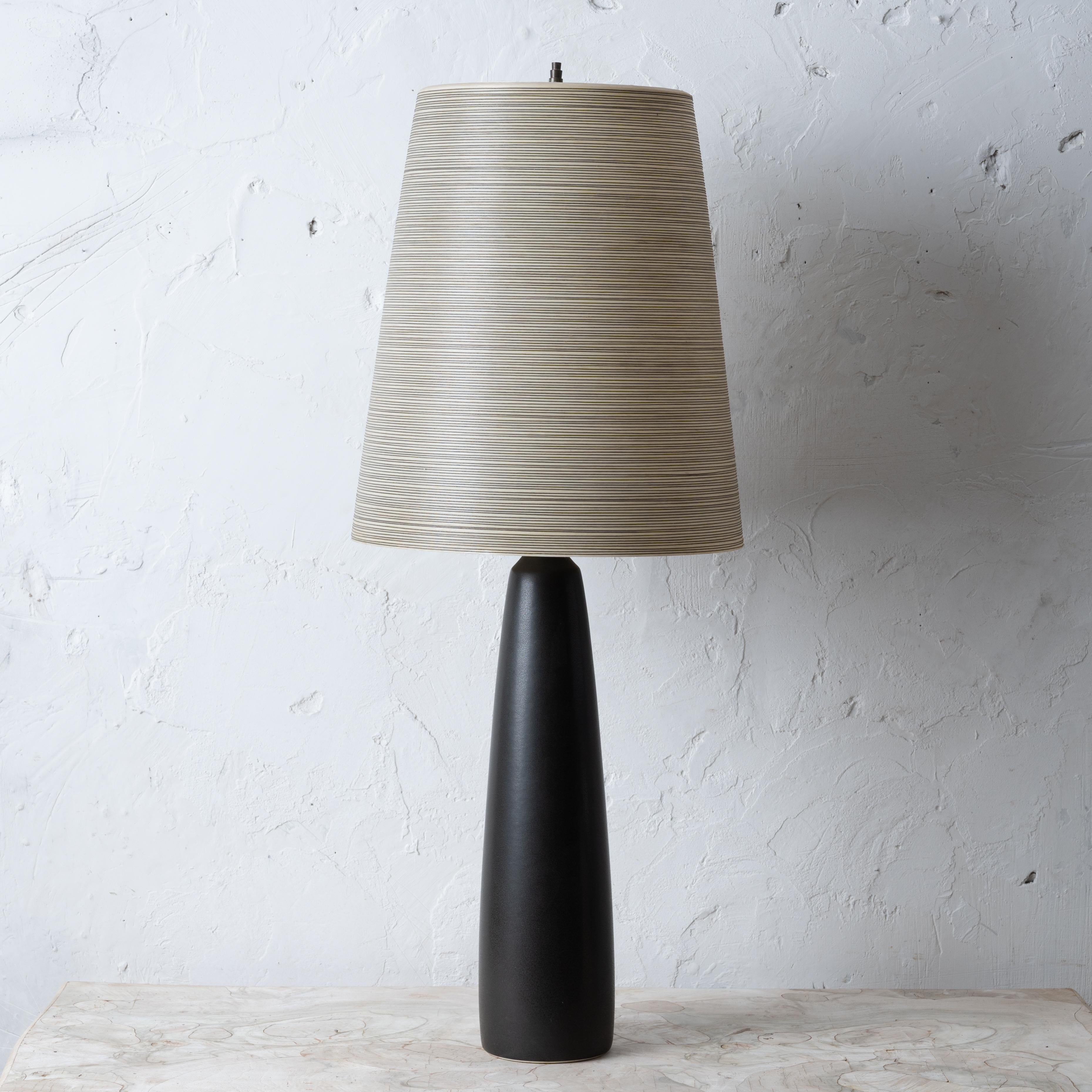 A Lotte and Gunnar Bostlund table lamp with original fiberglass shade, 1960s.

5 inches wide by 35 inches tall; shade 14 inches wide by 16 inches tall

