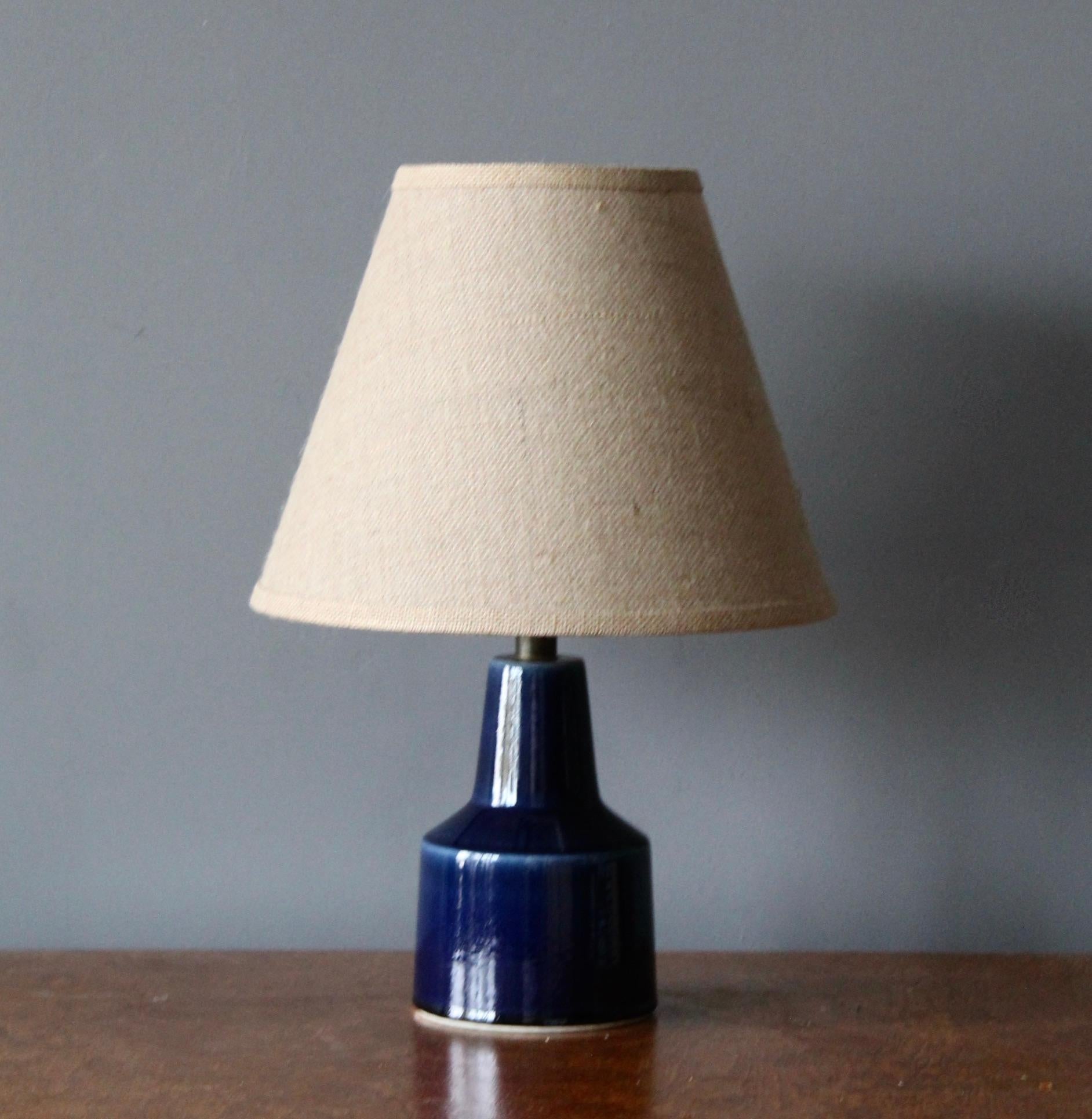 A table lamp designed and produced by Lotte and Gunnar Bostrom. A Danish duo operating in Canada. Produced c. 1960s.

Features blue glazed ceramic, metal. Sold without lampshade. Dimensions stated exclude lampshade, height includes