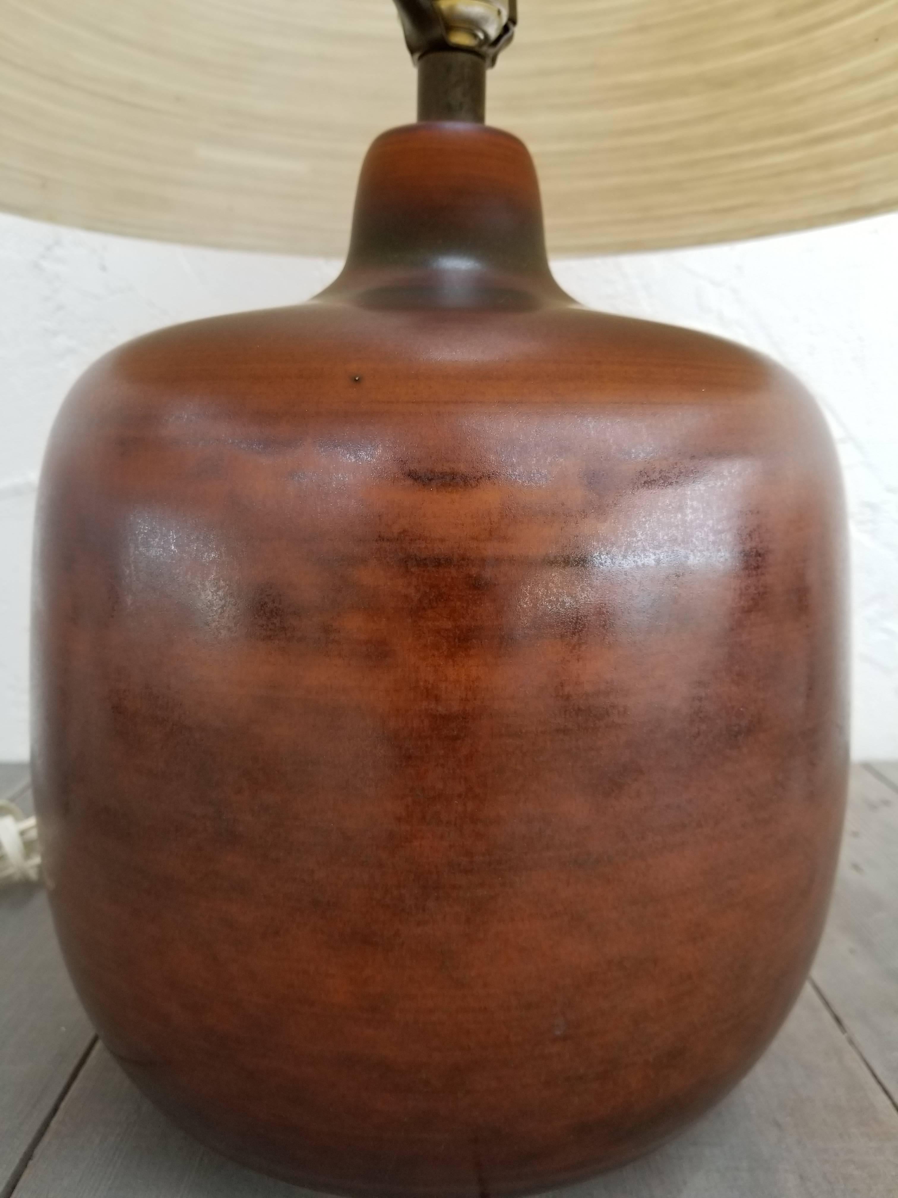 Beautiful, vintage Bostlund stoneware vase with a glowing, copper-like glaze and finish. Original shade of jute and fiberglass creates a soft glow. Very organic, very nice! Lotte and Gunnar Bostlund were Danish trained and created their lighting in