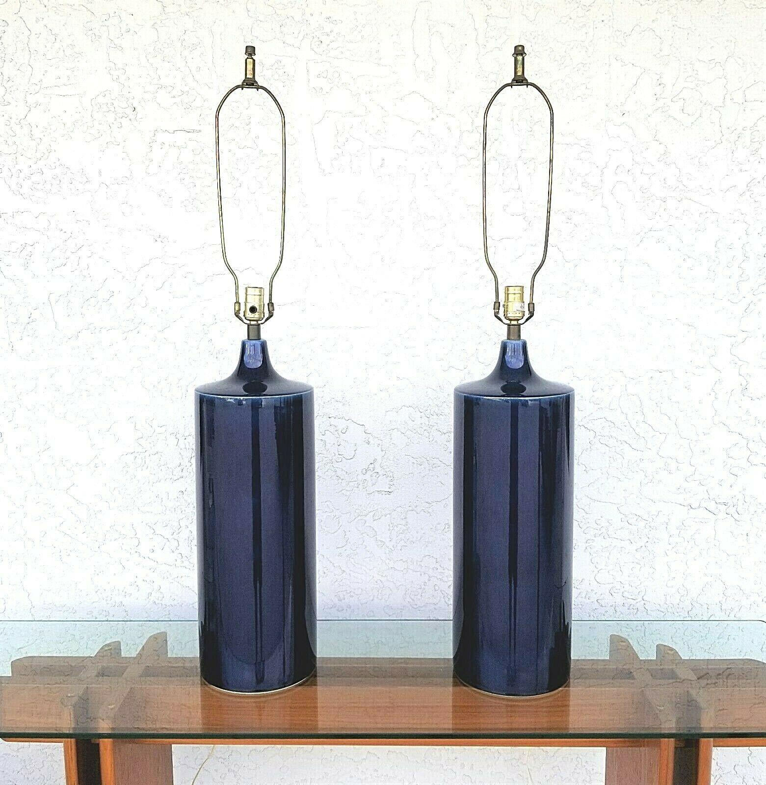 Offering one of our recent Palm Beach Estate fine lighting acquisitions of a
rare pair of large lotte and gunnar bostlund cobalt blue cylindrical ceramic table lamps with the original fiberglass shades, and retractable cords

Measurements
39
