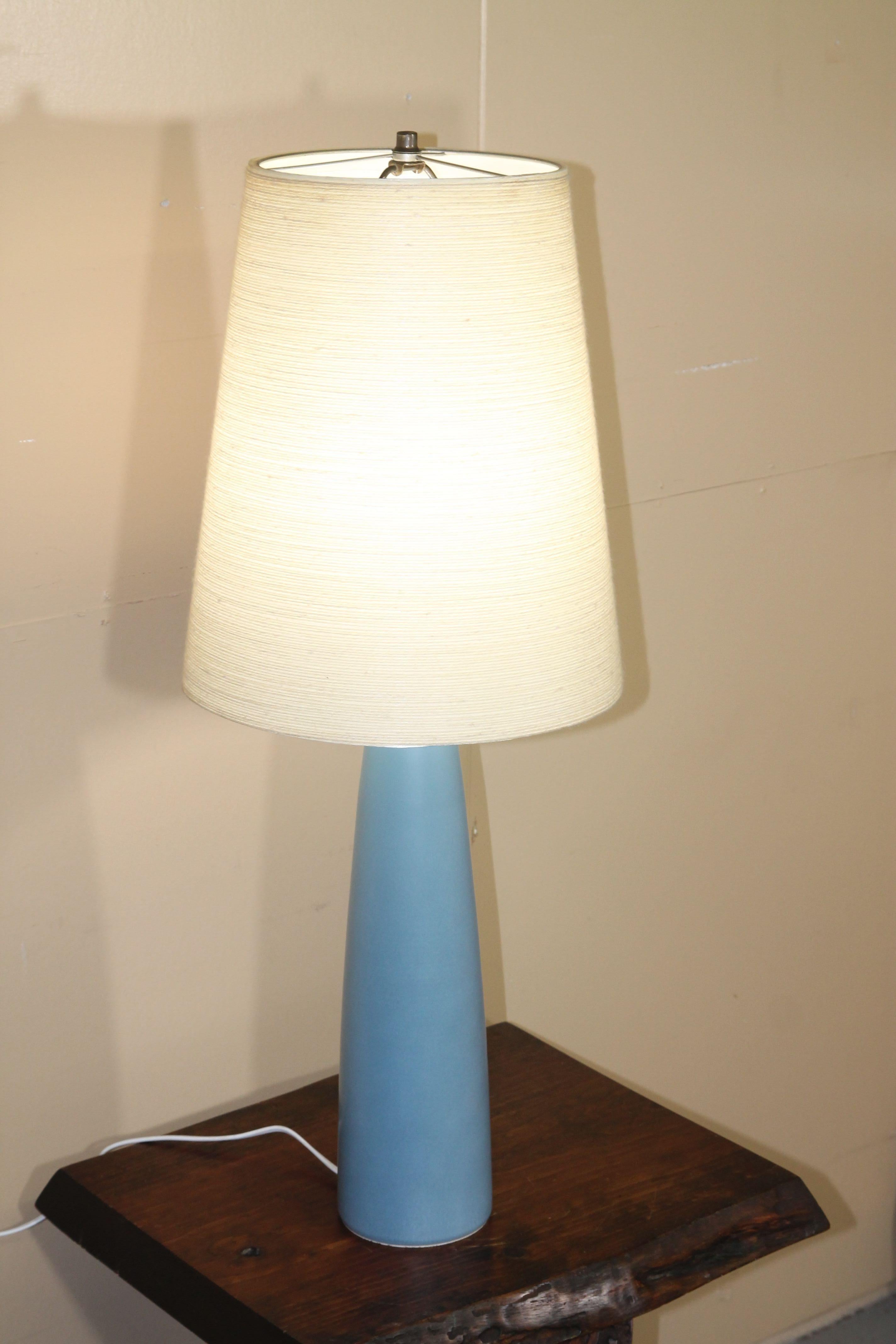 Wonderful Bostlund table with this light blue glaze and original shade. By far one of the best colors used by this company. Size of the lamp body is 5 inch in diameter and 18 tall. Diameter of the shade is 13.625 and overall height is 34.5.