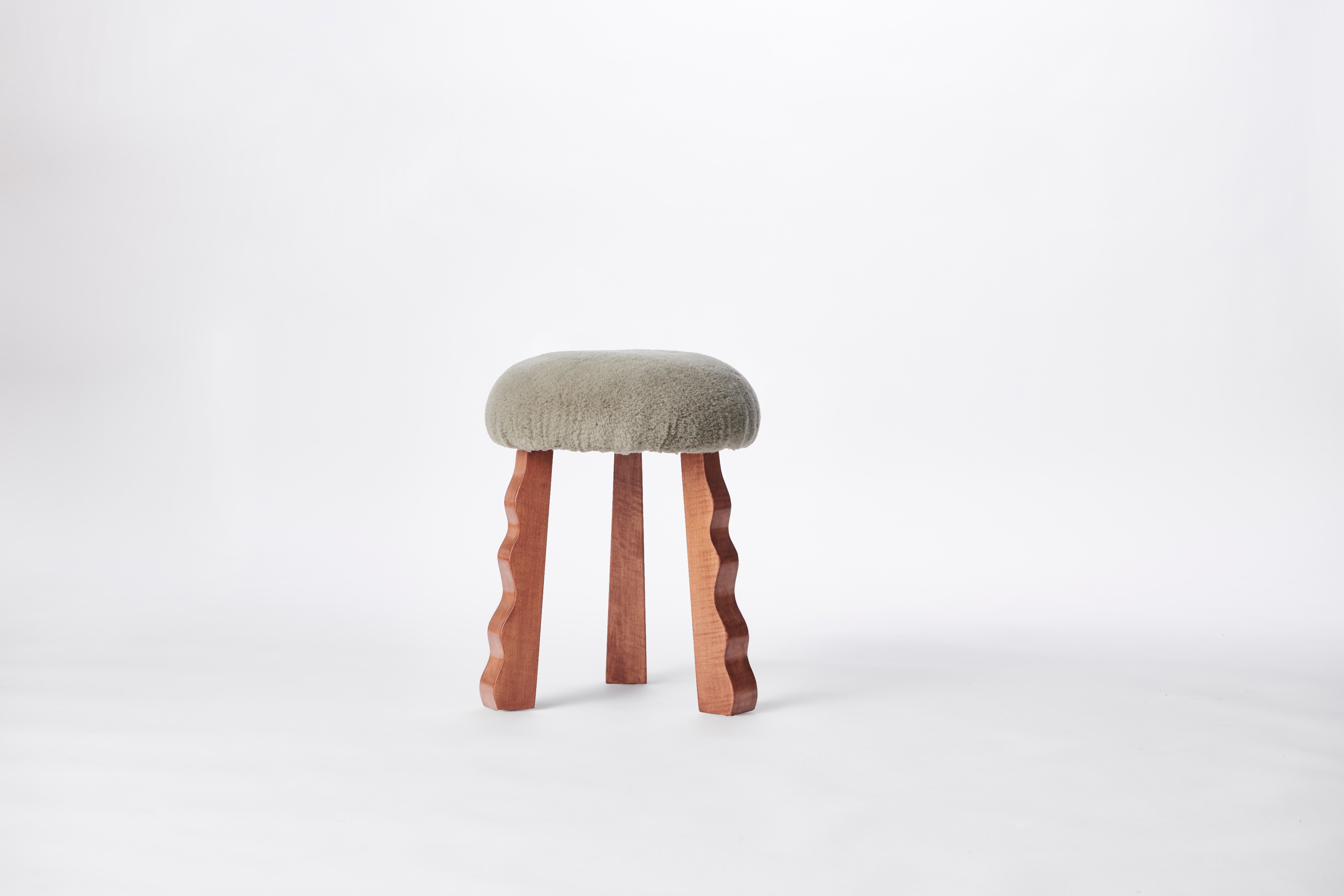 Made to order gray shearling and red oak stool designed by Christian Siriano.

Fabric: shearling (available in custom fabric)
Base: Red Oak (available in custom finish)

Dimensions: 
Top Diameter: 15”
Base Diameter: 16”
Overall Height: 18.5”
 