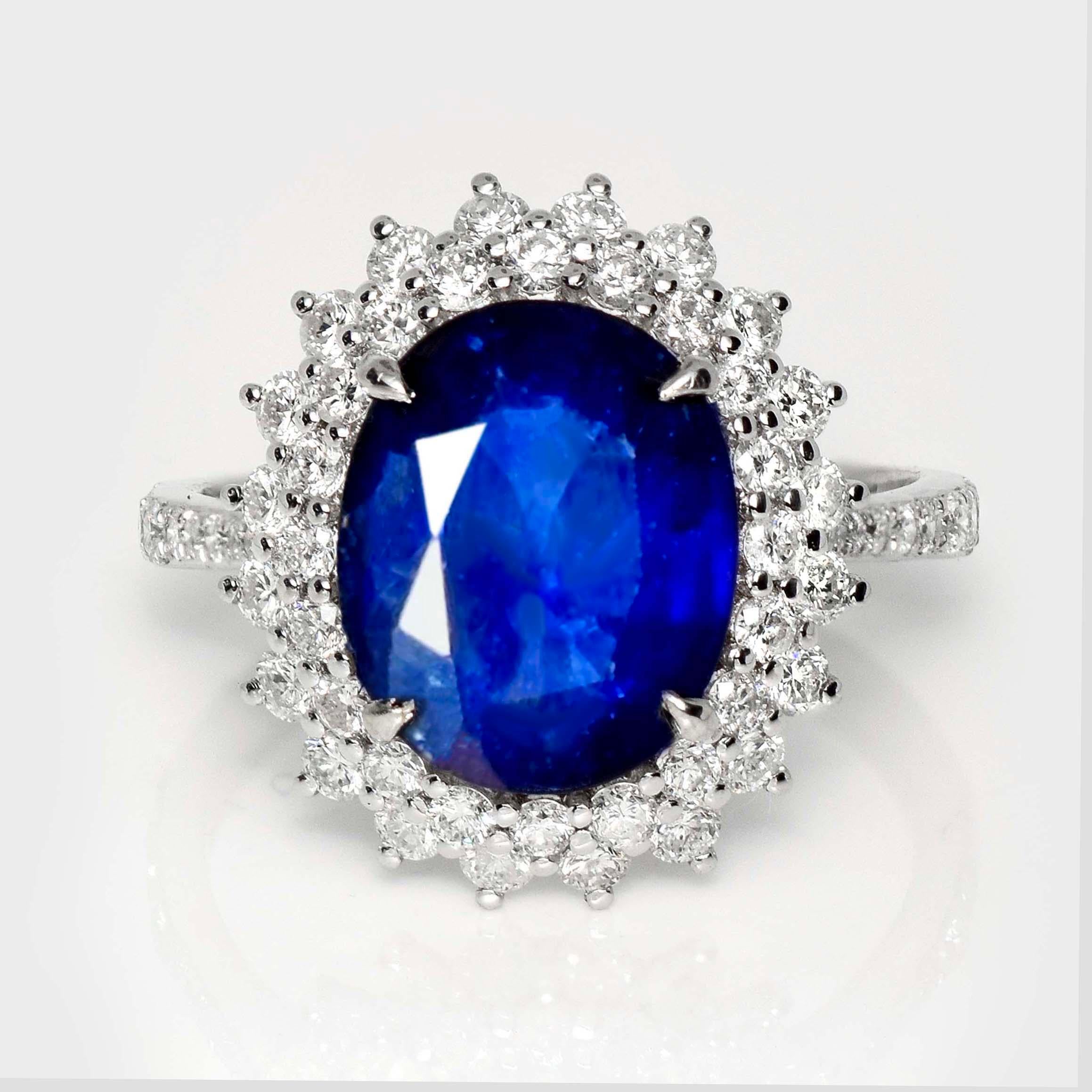 *Lotus 18K 4.87 ct Royal Blue Sapphire  Engagement Ring*
Lotus-certified natural royal blue sapphire as the center stone weighing 4.87 ct set on the 18 carat white gold halo design and pave' band with natural FG VS diamonds weighing 1.23 ct.  

The