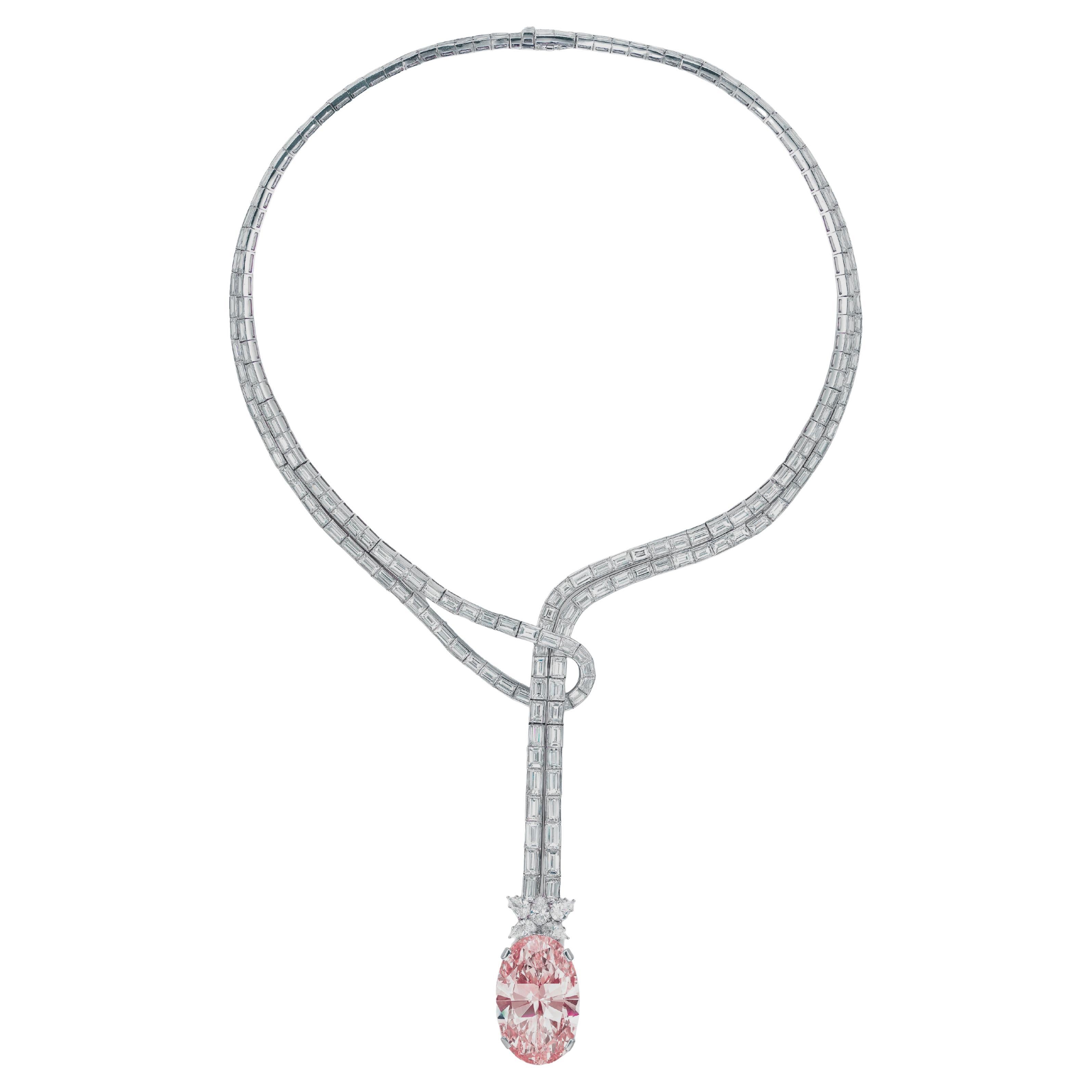 Set with an oval-shaped padparadscha sapphire weighing 10.28 carats, surmounted by a pear-shaped diamond floret, joined to the baguette-cut diamond double-strand necklace terminating in a loop, mounted in 18k white gold