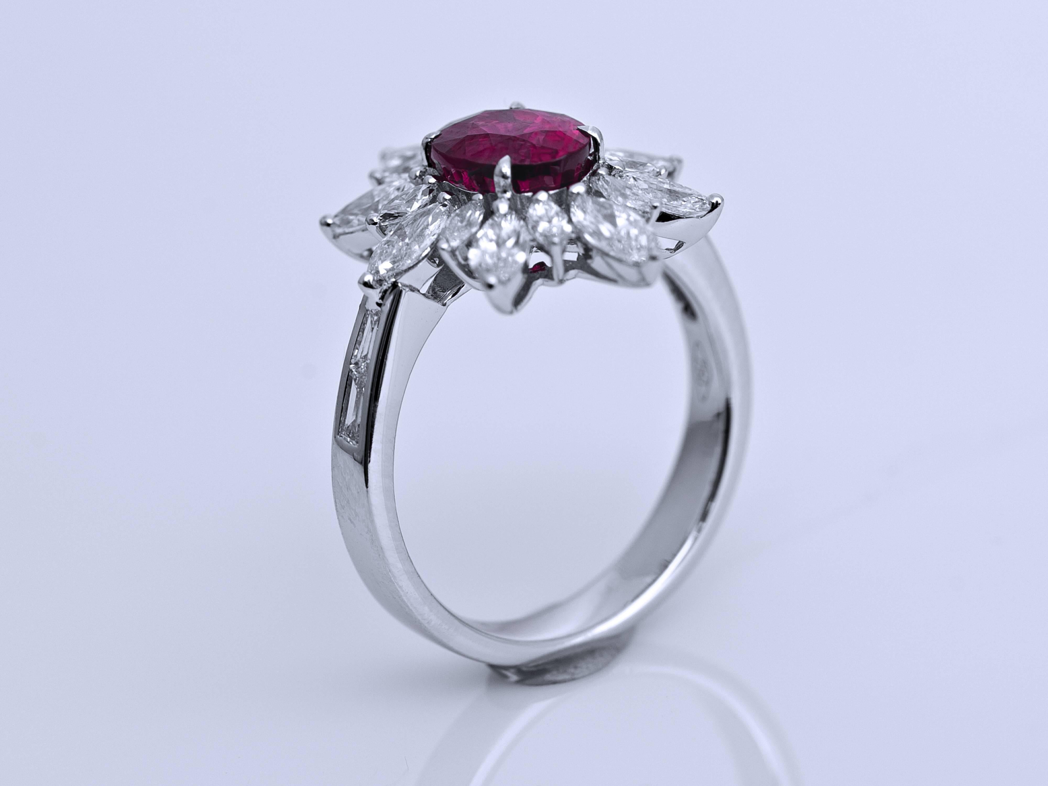 The oval shaped 2.15ct Burma pink sapphire set in the centre of the ring, framed by 16 Marquise-shaped diamonds in variating sizes and four baguette cut diamonds on the sides of the ring. A stunning piece for an elegant lady. 