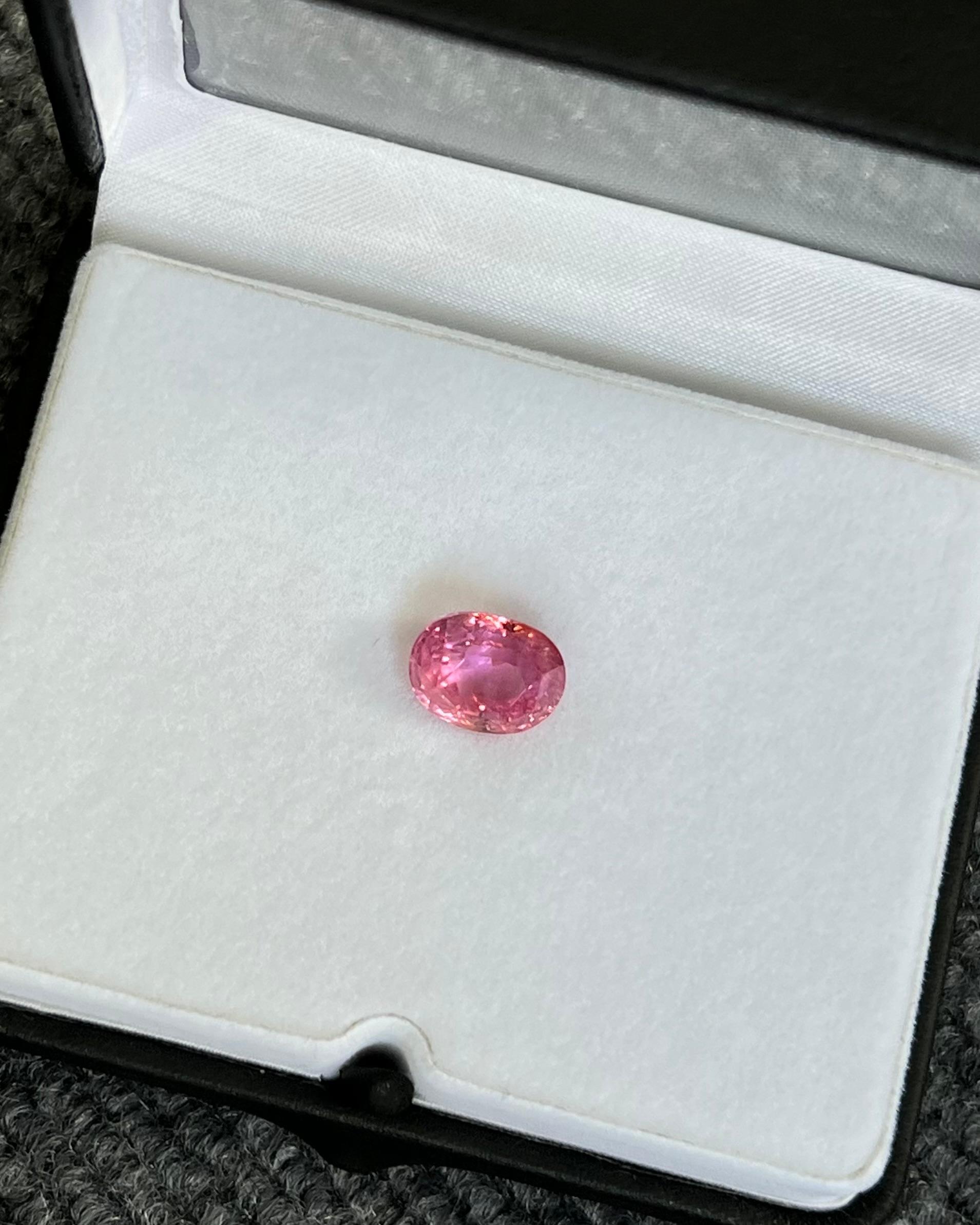 This stunning 8.25 carat natural, non-heated padparadscha sapphire showcases a captivating blend of pink and orange hues. This exquisite gemstone originates from Sri Lanka renowned for being the home of the most exceptional padparadscha sapphires.