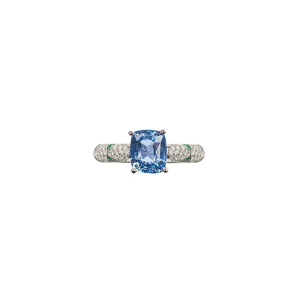 Significant cushion cut Ceylon Sapphire solitaire set in Ri Noor’s iconic lotus motif rings. This statement ring features an emerald solitaire set with emerald petals in a lotus motif and pave set brilliant cut diamonds. Wear it alone as an