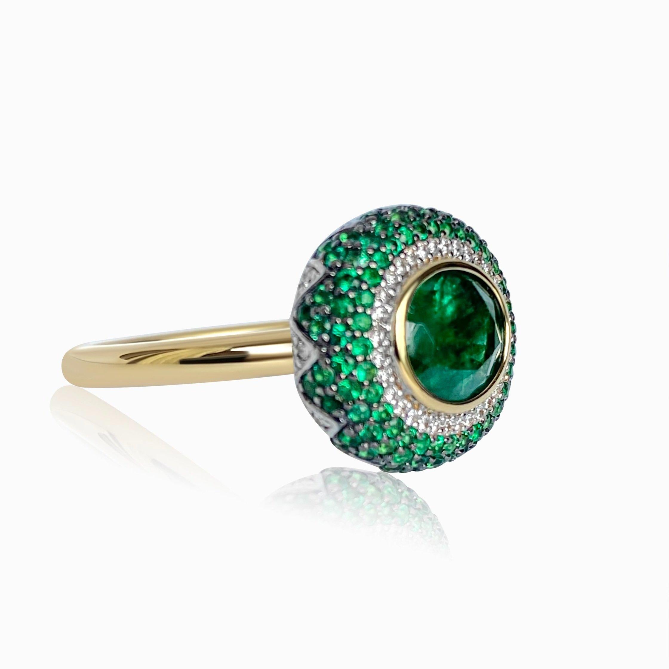 14k Yellow Gold. These any-finger rings include a dazzling OVAL-shaped emerald solitaire of approximately 2cts, pave set emerald petals in a lotus motif, and pave set brilliant cut white diamonds. Rinoor's re-imagined rings, are incredibly versatile