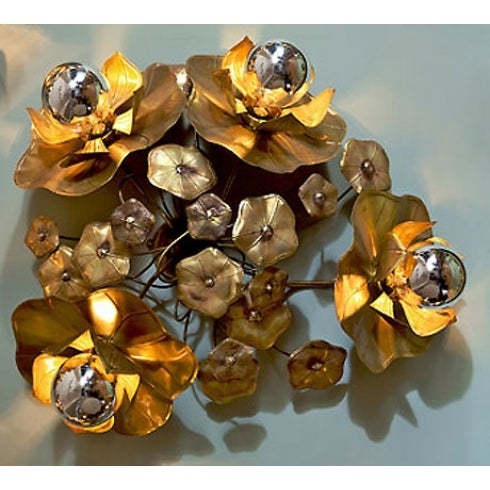 These ultra glamorous lotus flower wall lights provide perfect mood lighting either singly, as a cluster, or as an entire wall installation. Made in solid brass and soldered with silver these organic sculptures appear to grow out of the wall. Each