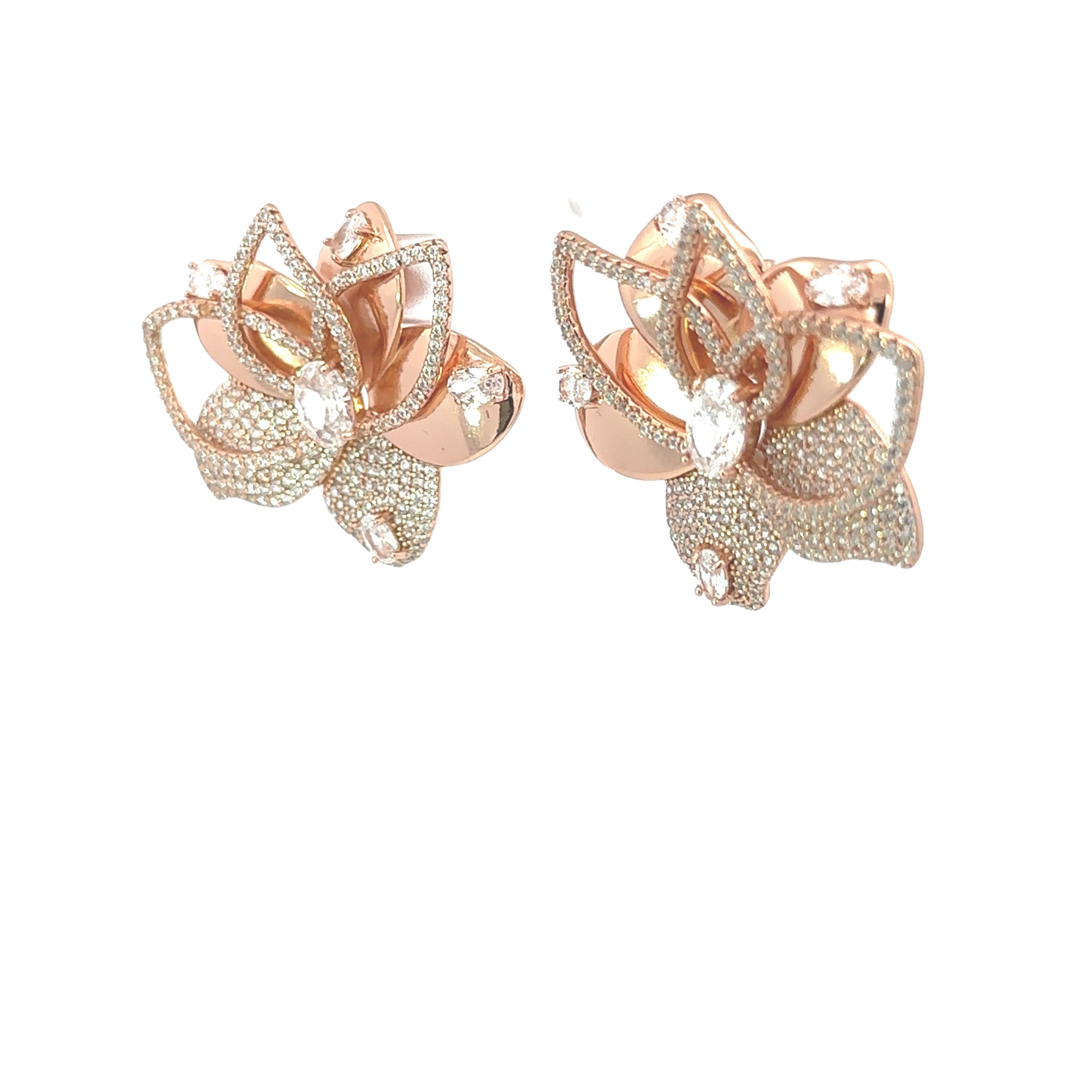 Lotus Flower Rhinestone Crystal Earrings in sterling silver. You shall need these statement studs to make a statement with your look. Each piece features dazzling cubic zirconia stones, renowned for their brilliance and clarity, set in high-quality