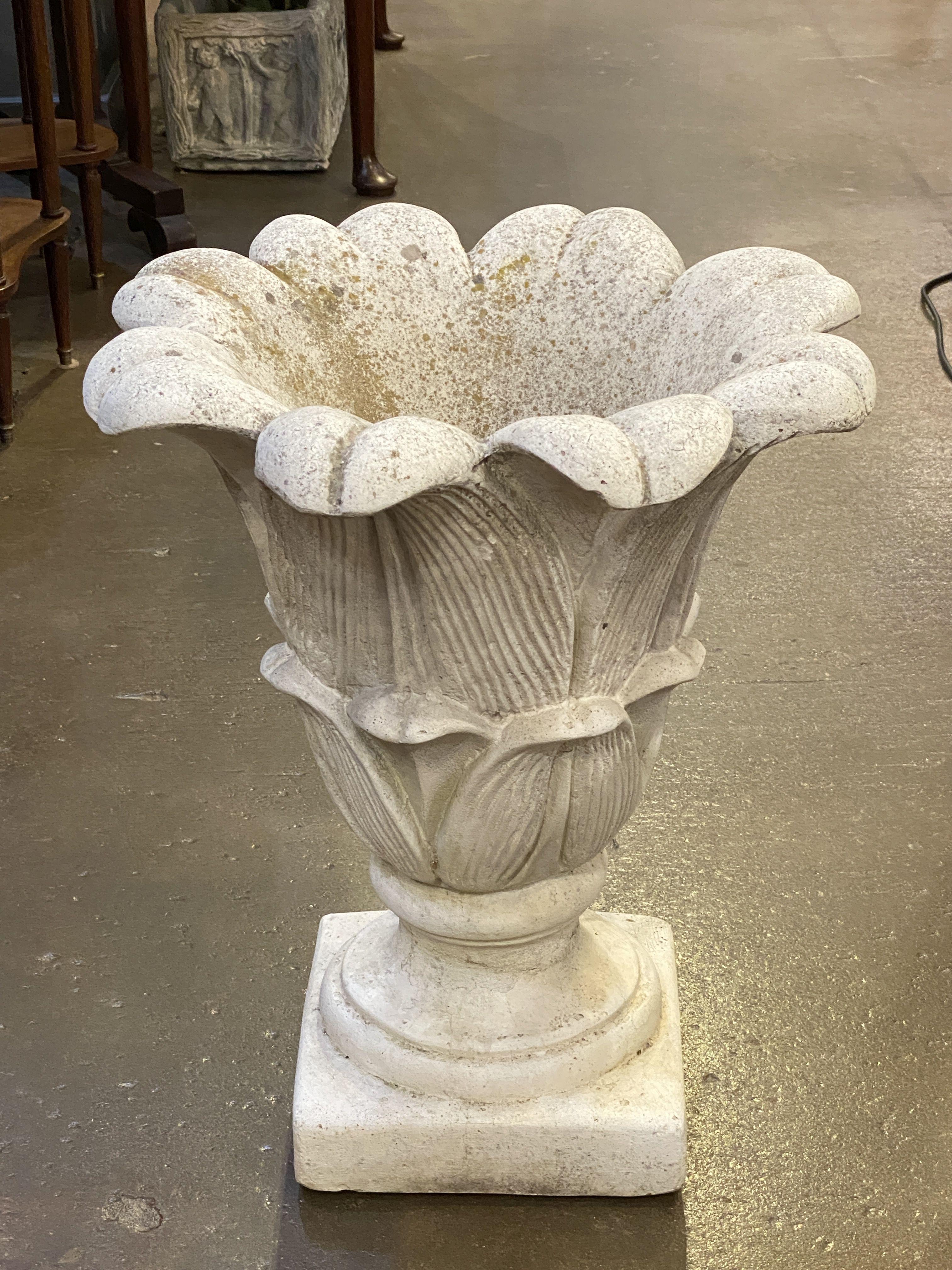 A fine Italian garden stone planter pot or urn on a raised square pedestal platform or plinth, featuring a relief design of a lotus flower. Interior with optional or removable iron collar.

Dimensions are H 23 inches x Diameter 19 inches

Base