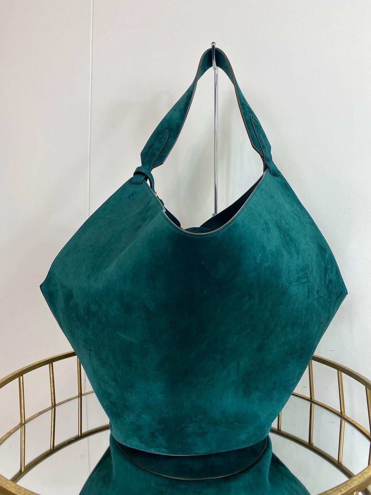 Blue Lotus Khaite bag in petrol-colored suede.