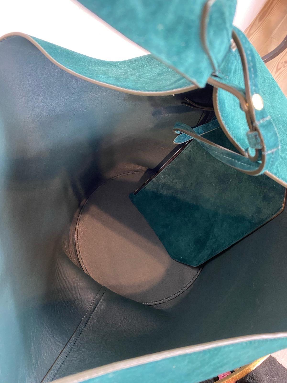 Women's or Men's Lotus Khaite bag in petrol-colored suede.