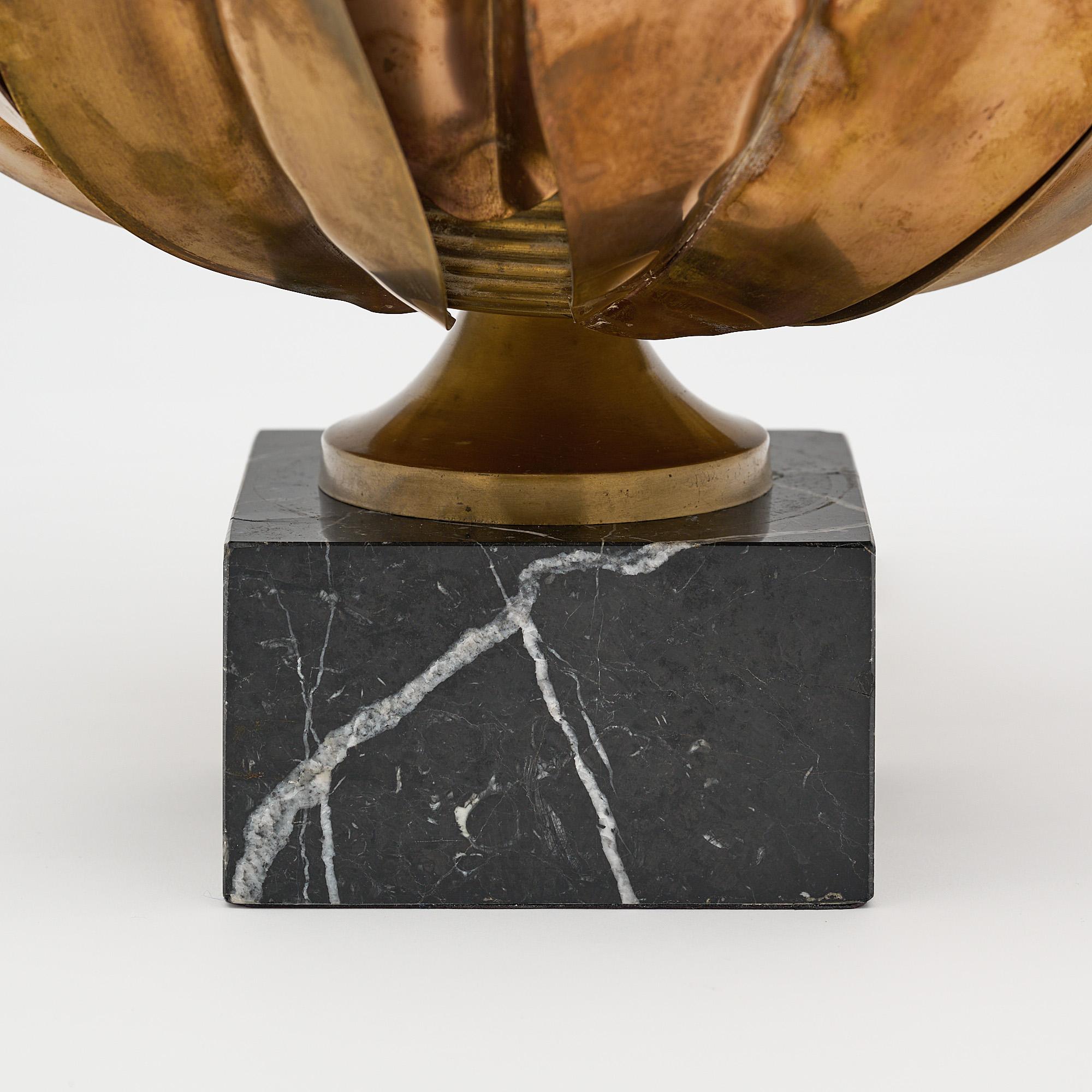 Lamp, French, in the modernist style by Maison Charles. The lamp features an array of hand embossed brass leaves flaring out “En Corolle” with a black veined marble base. Rewired to US standards.