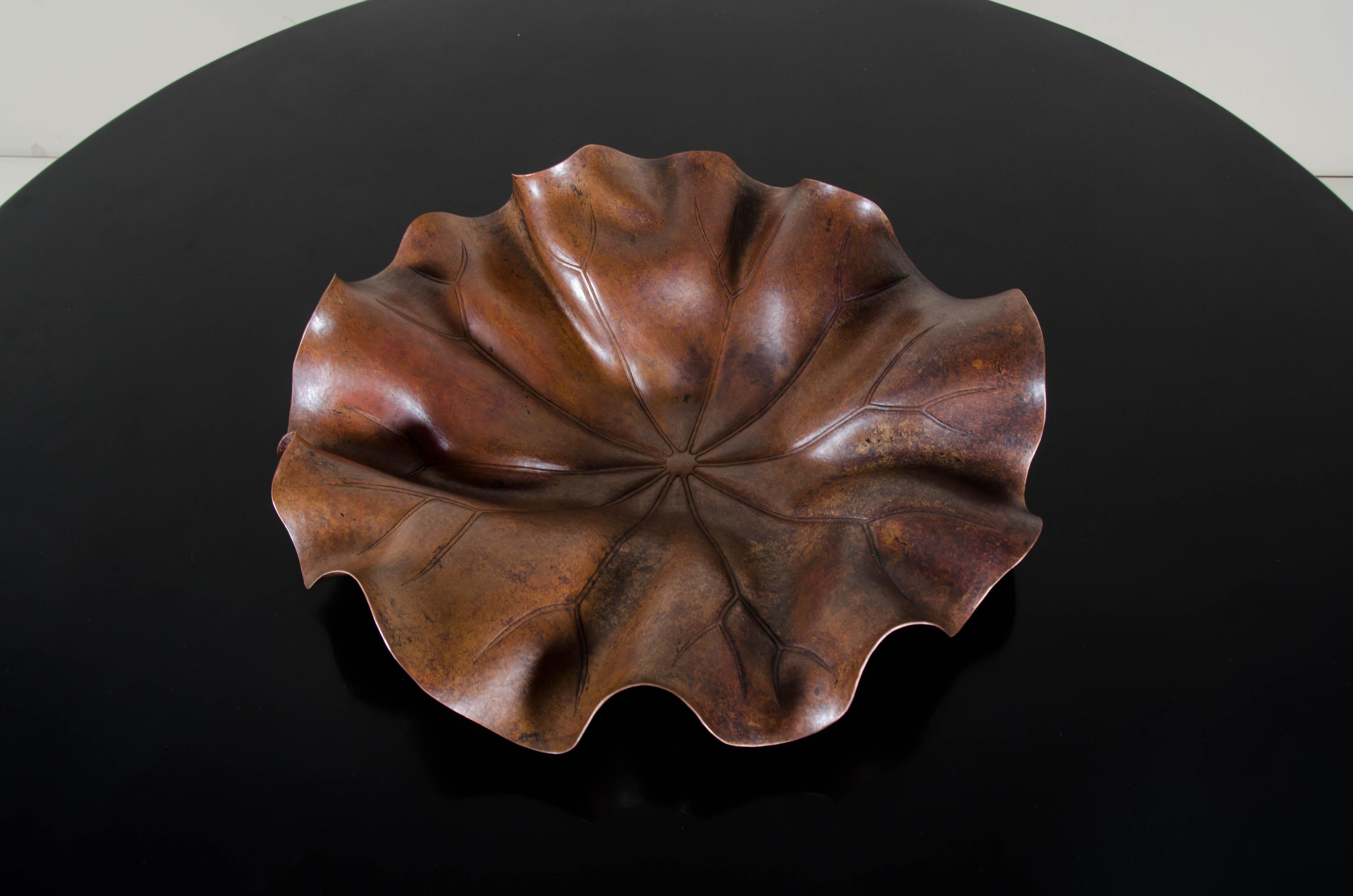 Lotus leaf plate
Antique copper
Hand repoussé
Limited edition

Repousse´ is the traditional art of hand-hammering decorative relief onto sheet metal. The technique originated around 800 BC between Asia and Europe and in Chinese historical