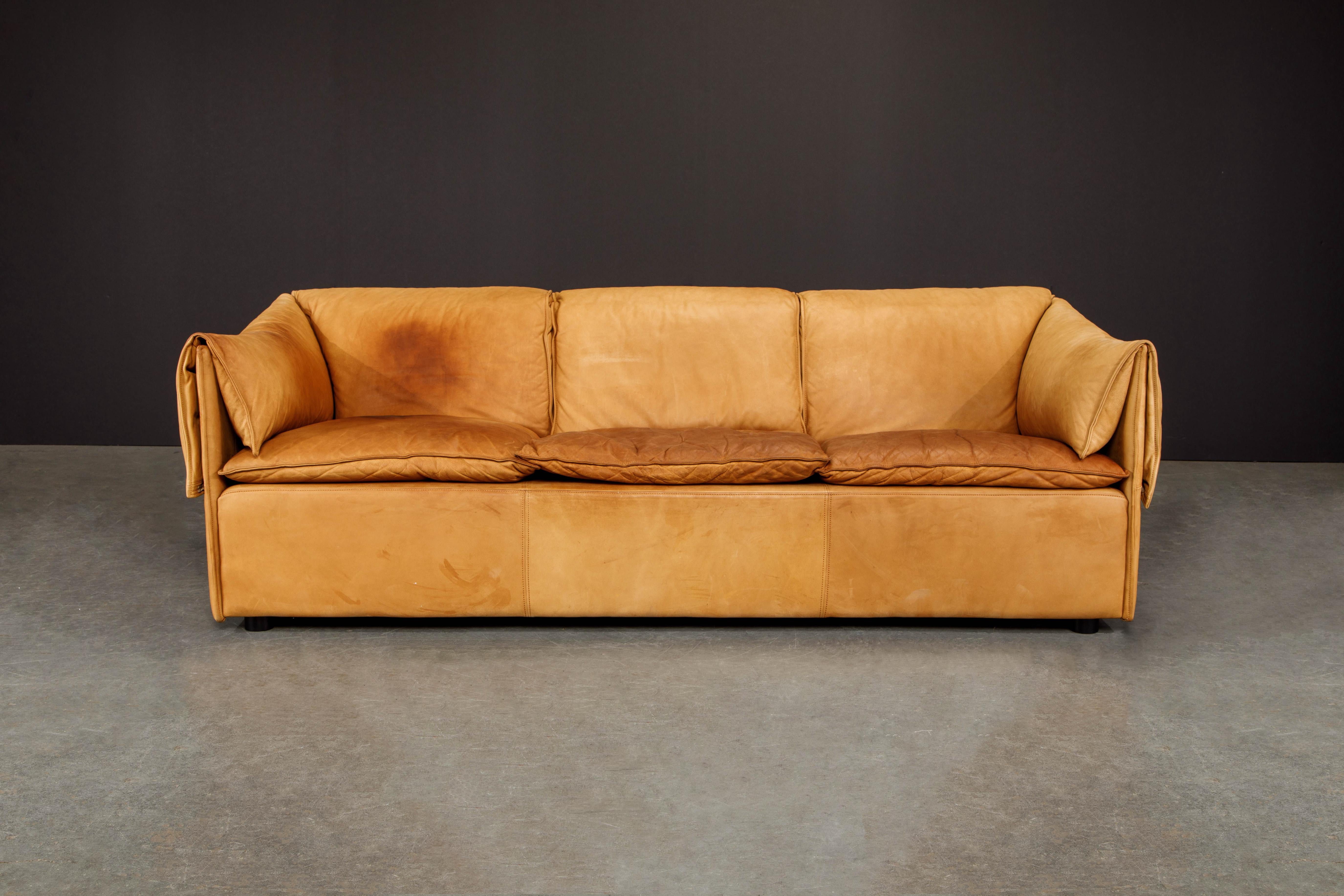 This beautifully patinated leather 'Lotus' sofa by Niels Bendtsen for Niels Eilersen is covered in comfy Danish glove-soft leather. Featuring three loose seat cushions with draped and zipper attached cushions that fold over the the back and sides.