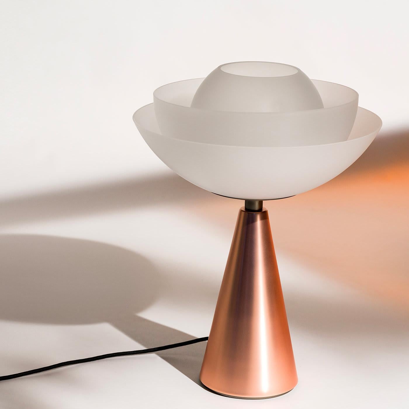 This striking Lotus metal table lamp will bring a dynamic elegance to your living room, lounge room or bedroom. The sleek base in galvanized metal with a matte copper finish is complimented with a diffuser in clear blown acid etched glass. A simple