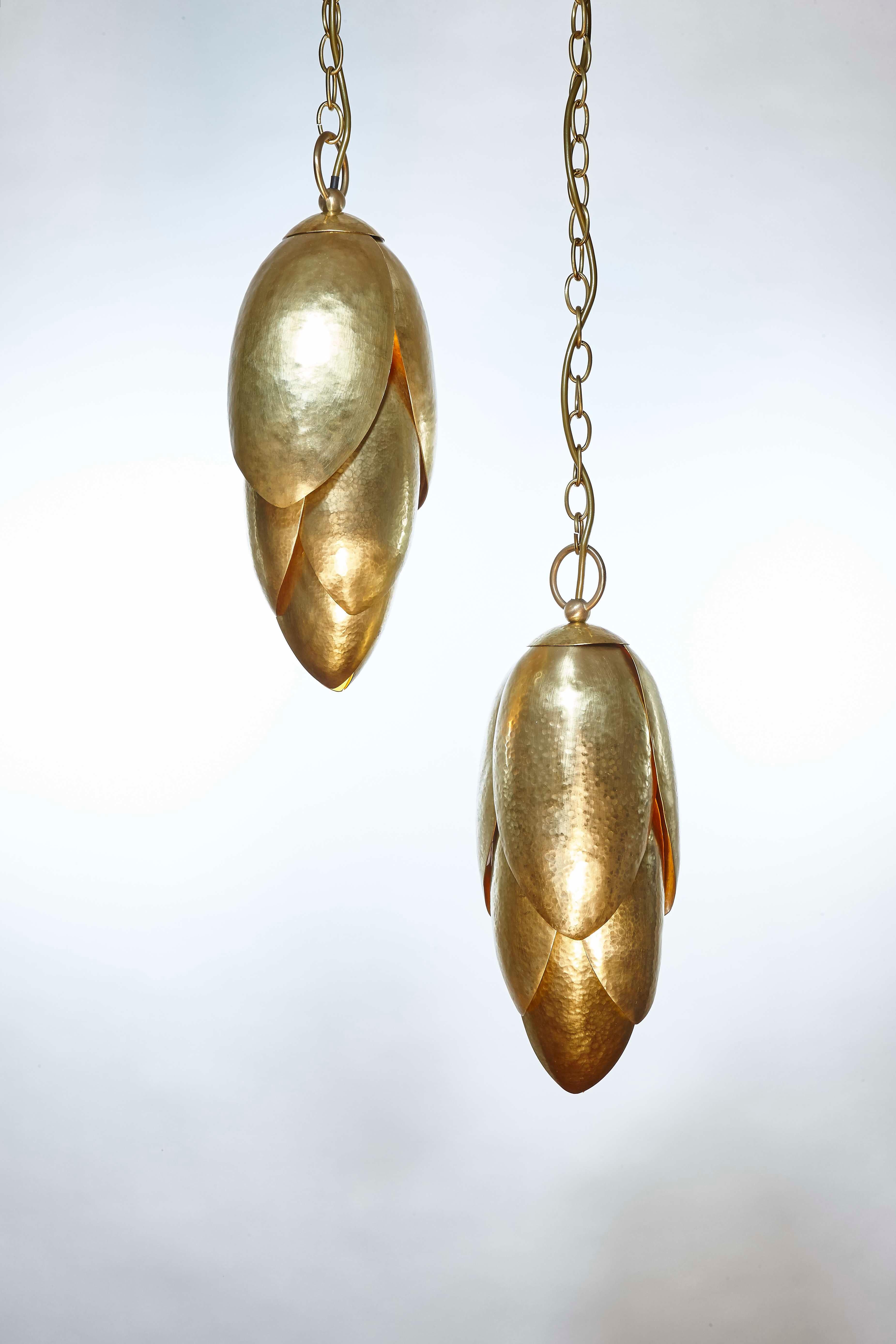 The design inspiration for these beautiful pendants was taken from the petals of the lotus flower, symbolising purity, strength and resilience. Each petal is carefully hand-hammered in bronze. The perfect statement piece over a staircase, above a