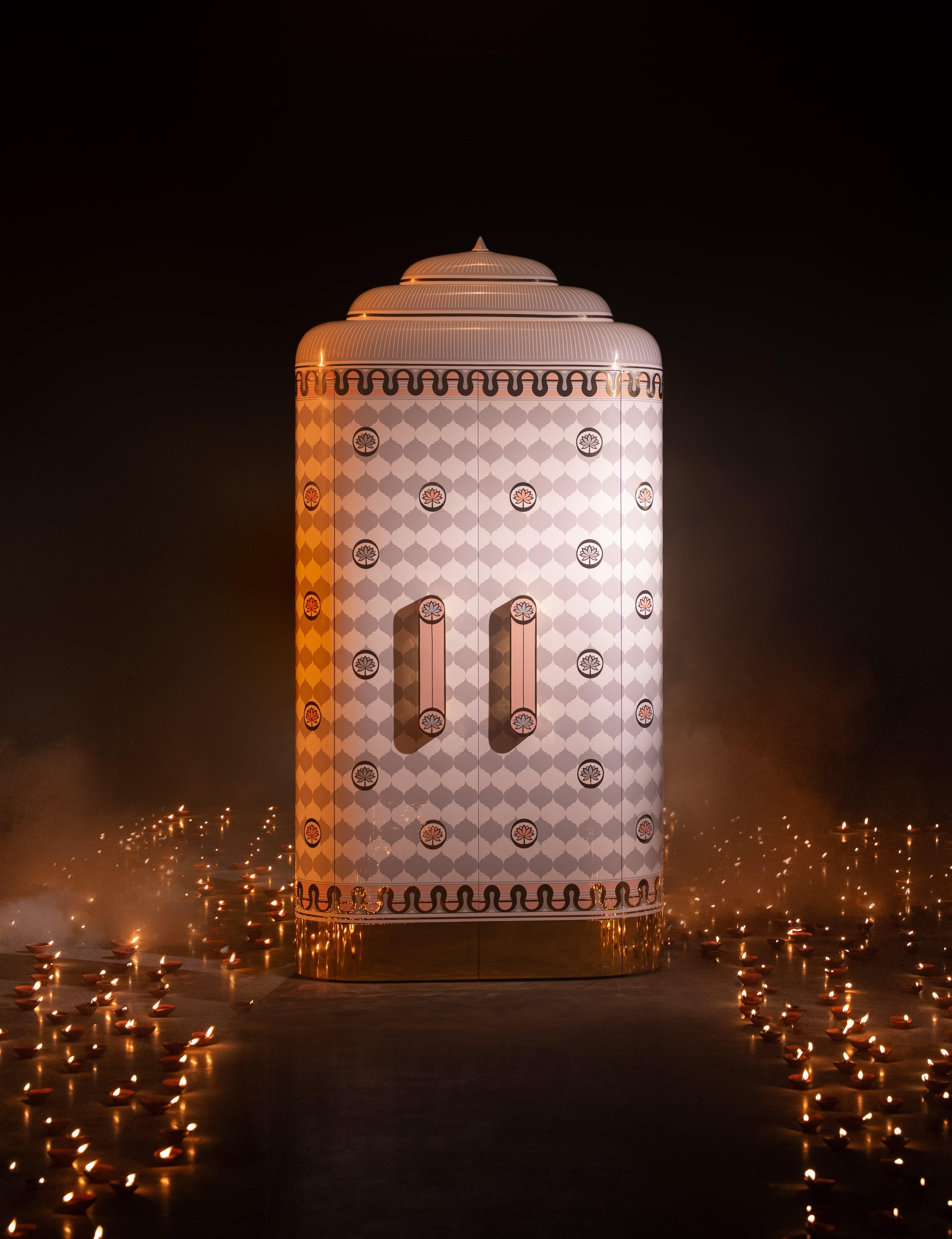 A spectacular cabinet in mammoth proportions, Lotus Sanctum Regalia has arches and motifs created with brass and resin marquetry. The internals are finished in gleaming brass. It can be customised in terms of size and colour 

Each piece from this