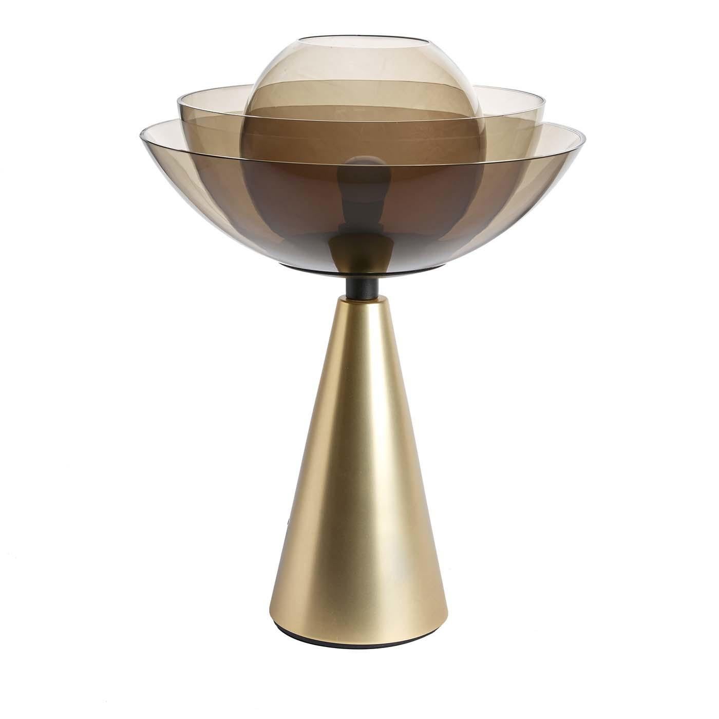 A fascinating design inspired by the lotus flower, this stunning table lamp embodies elegance, perfection, purity, and grace. Designed by Serena Confalonieri, this lamp is composed of a cone-shaped base in brass-coated iron with a stunning shade