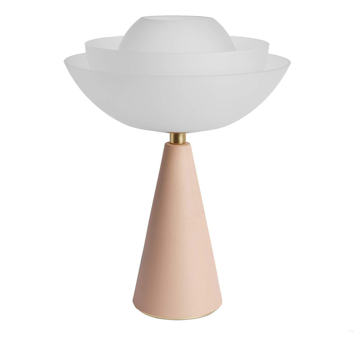 This sophisticated design by Serena Confalonieri is inspired by the lotus flower, symbol of perfection, purity and grace. Sensual and elegant, this table lamp has a 1960s vibe with a conical base made of iron and finished in a romantic, pastel shade