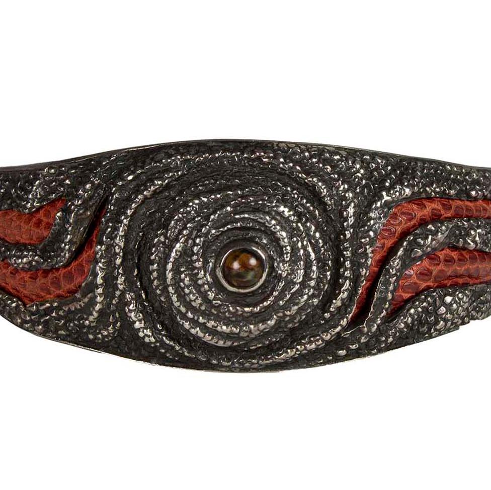 Product Details: Rare - Silver Cuff Bracelet - Central ‘Tigers Eye’ Stone - Leather Outer Inlay Detail - Leather Lining Detail
Artist: Lou Guerin - Unsigned 
Fabric Content: Silver / Leather / Tigers Eye Stone
Condition: Rare Collectors Piece - New