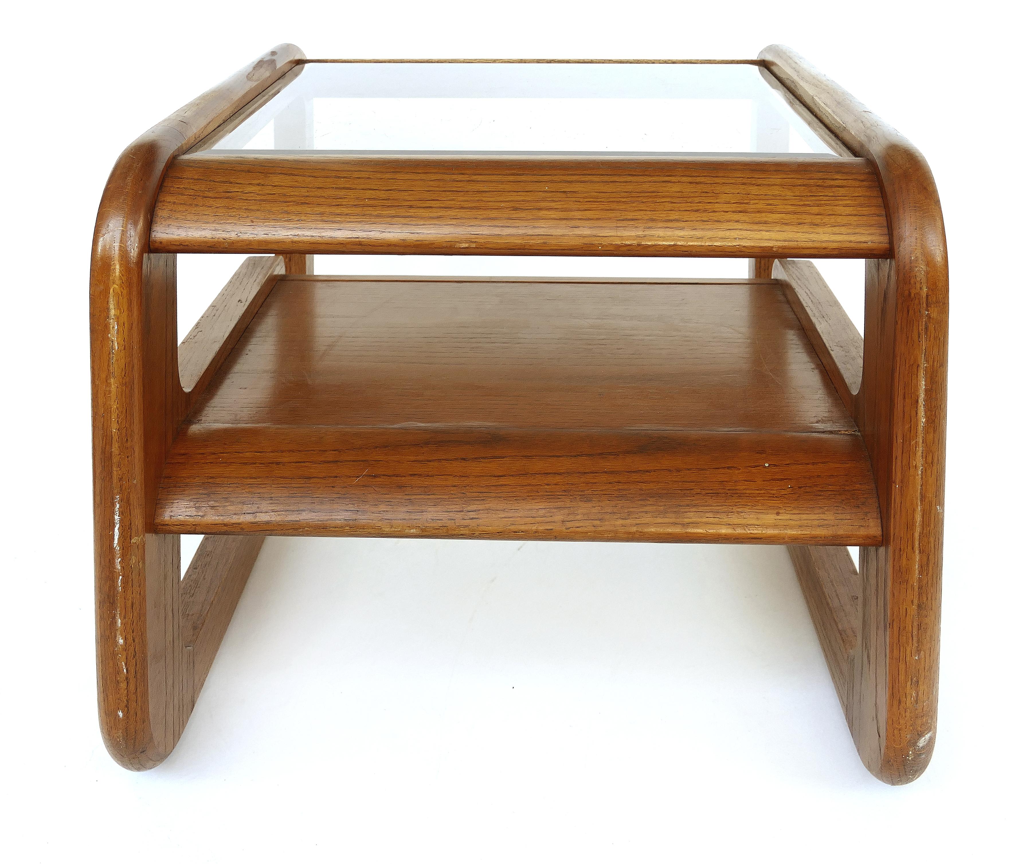 Lou Hodges California midcentury side table with inset glass

Offered for sale is a Lou Hodges California Mid-Century Modern two-tiered side table with an inset beveled glass top. The glass top is lightly smoked in color.