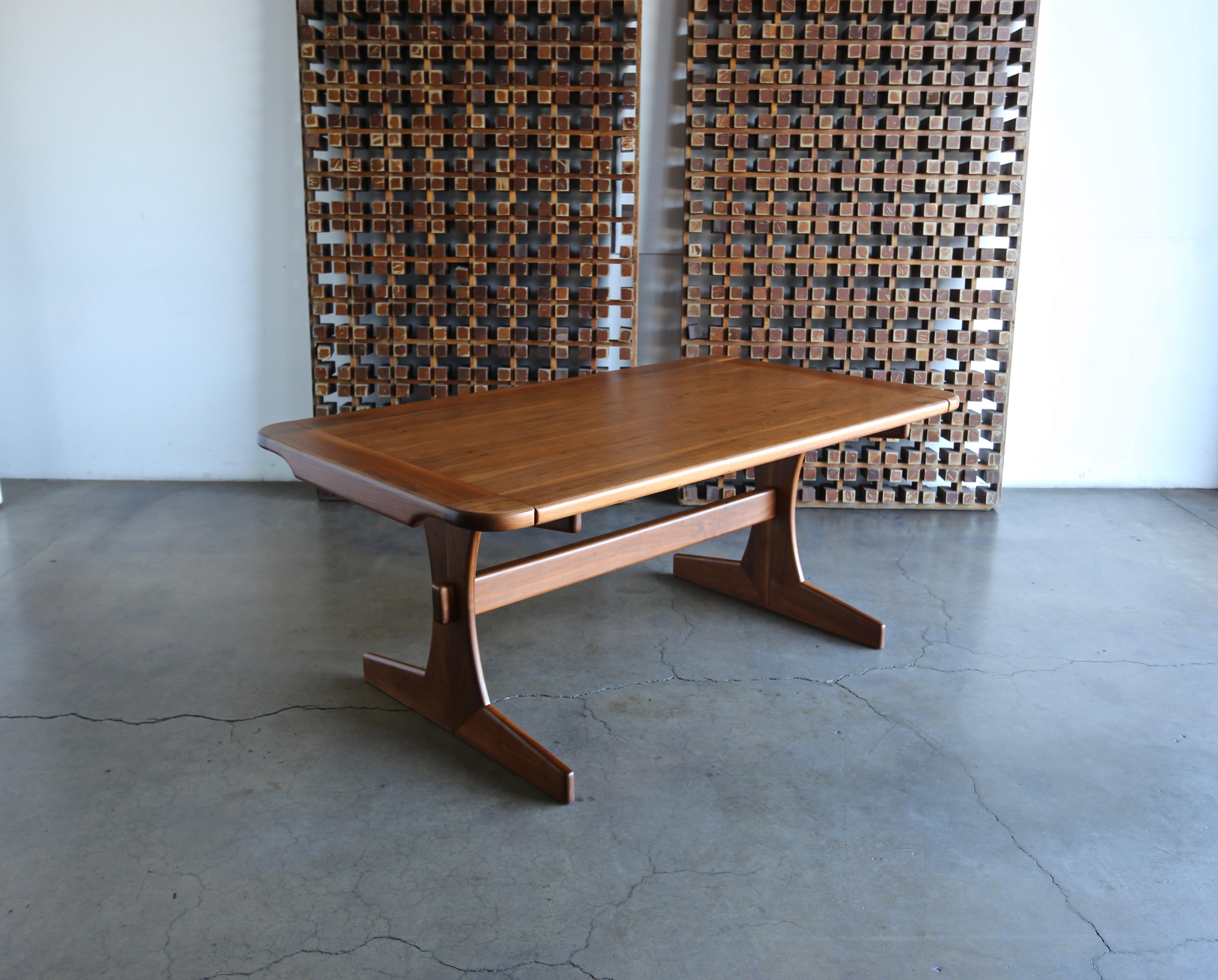 Lou Hodges walnut dining / writing table for California Design Group, circa 1975. This piece is signed to the bottom. Professionally restored.

This table extended to 95 5/8