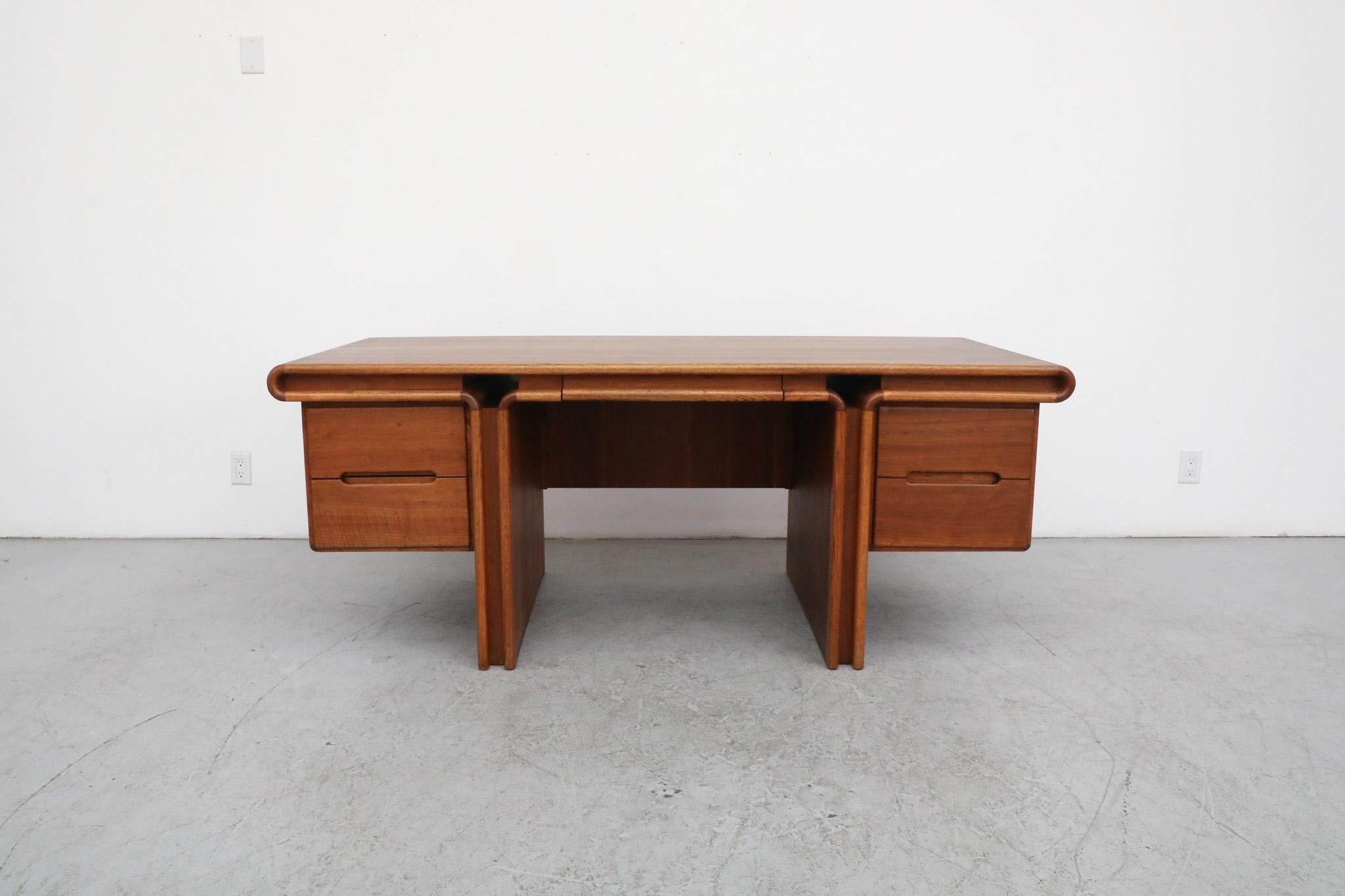 Stunning crafted executive desk by renowned California craftsman Lou Hodges in walnut, oak and koa woods for Creative Crafts, circa 1960. Heavy desk with beautiful curvatures and accents with mixed grains that compliment its masterful style. Lou