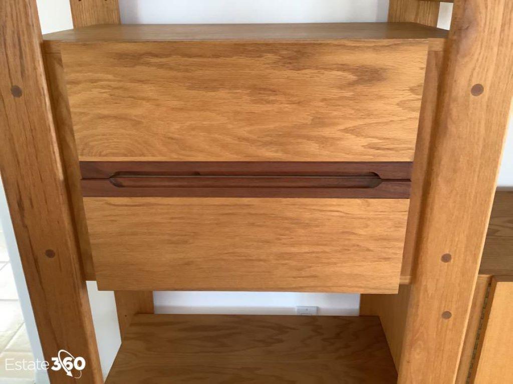 This is a beautifully crafted wall unit by Lou Hodges. The unit includes eight large adjustable shelves and four fixed cabinets.