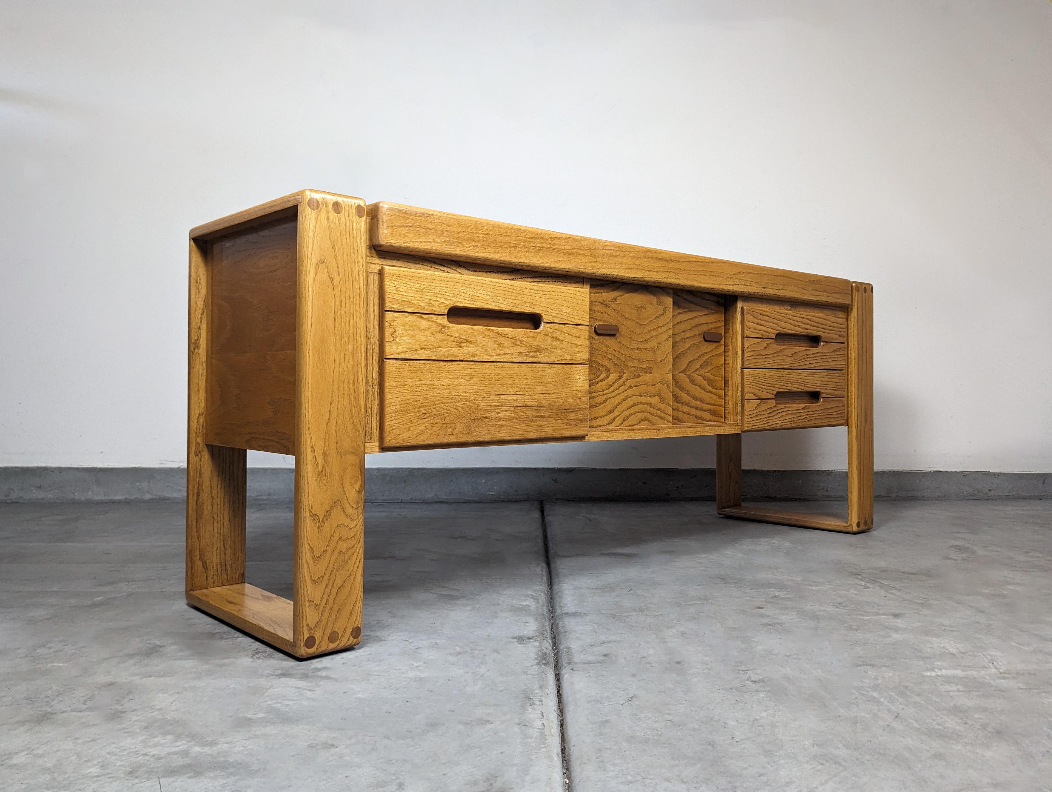 For sale is a meticulously refinished credenza, an authentic piece designed by the renowned Lou Hodges for the California Design Group in the 1980s. This stunning piece is a perfect blend of form and function, making it a timeless addition to any