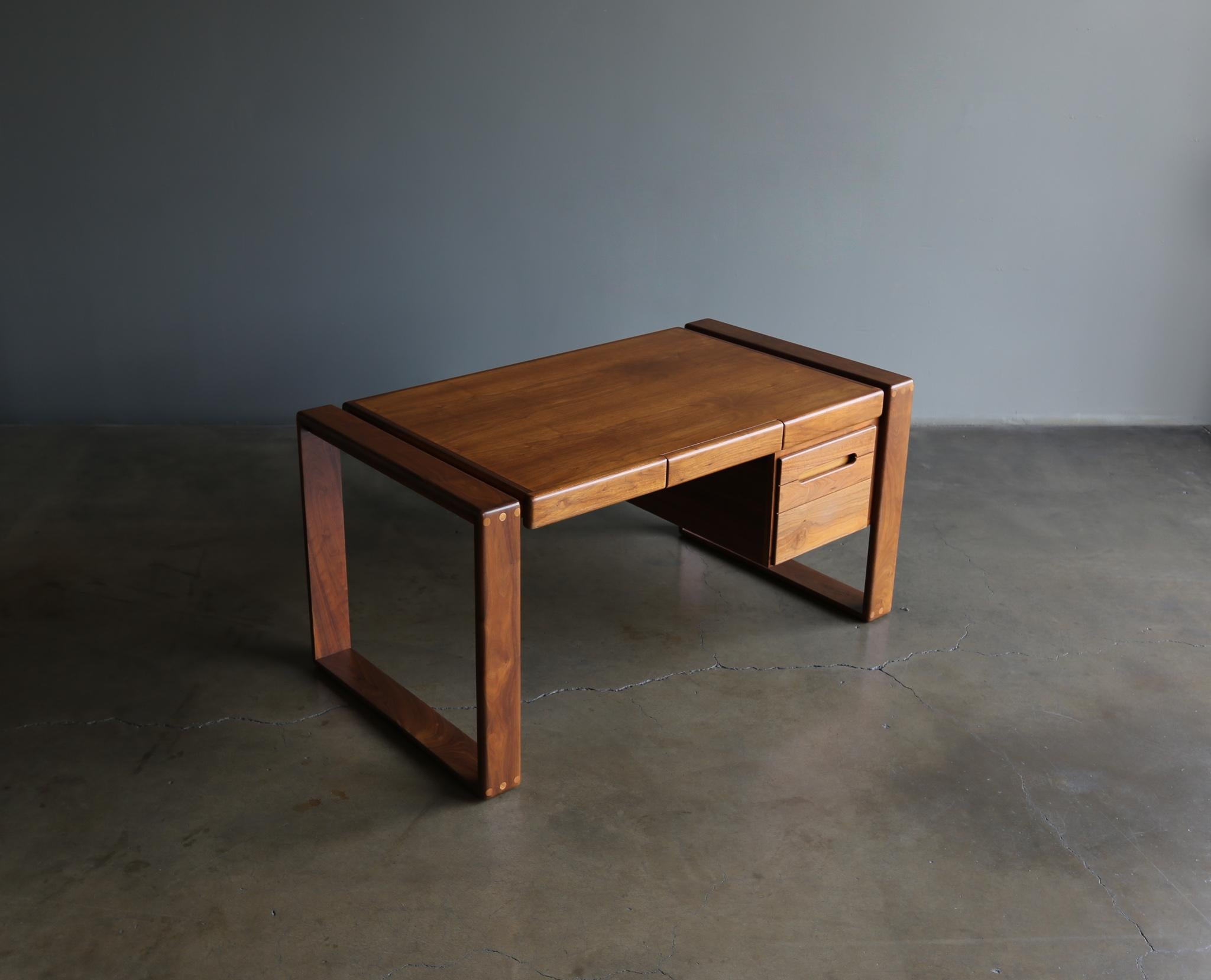 Lou Hodges handcrafted walnut desk for California Design Group, 1979. This piece has been professionally restored. Signed to the drawer interior.