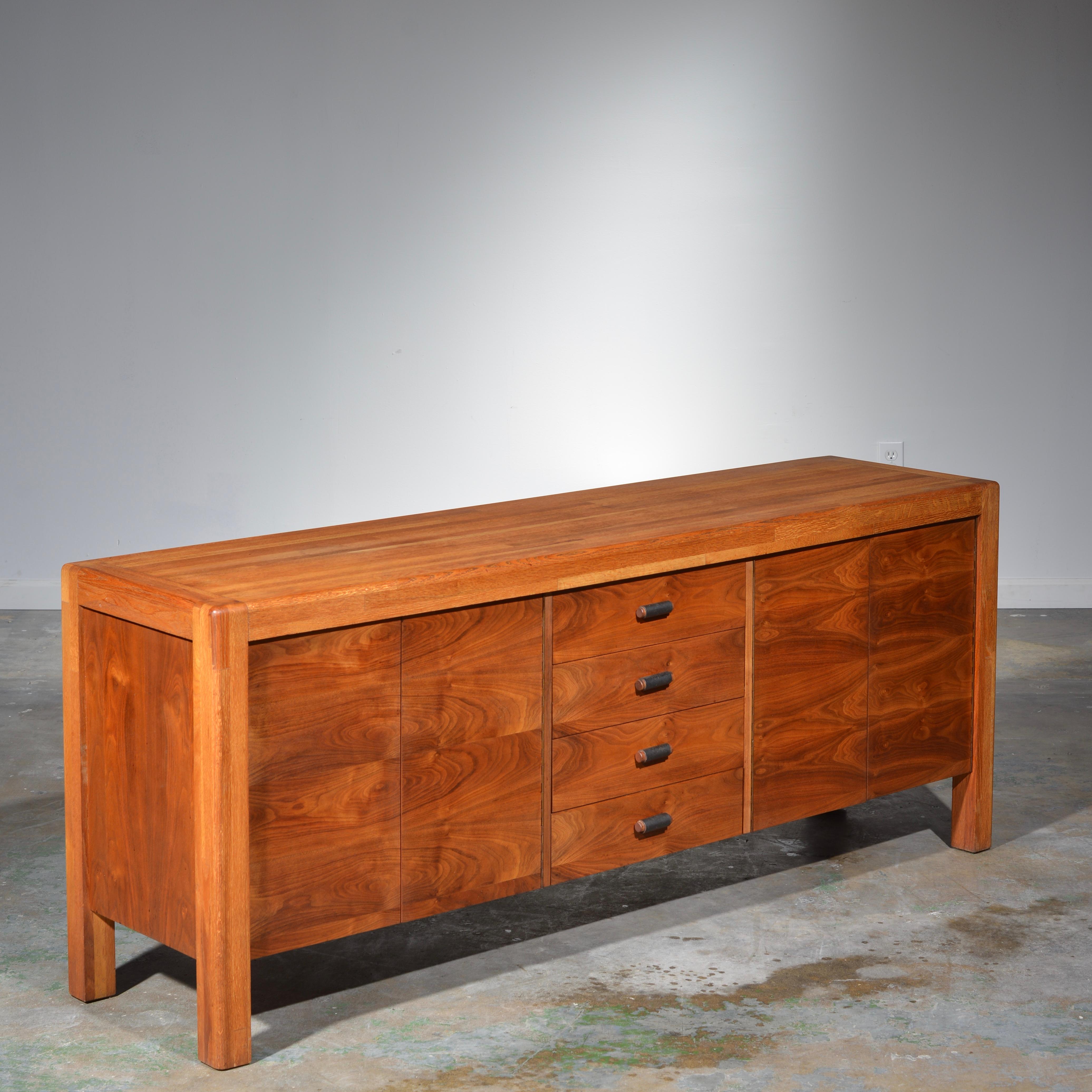 This is an amazing a very rare credenza by the great California designer Lou Hodges. Handcrafted in oak butcher block and walnut casing. In excellent condition. Makers mark located on the inside of casement door.