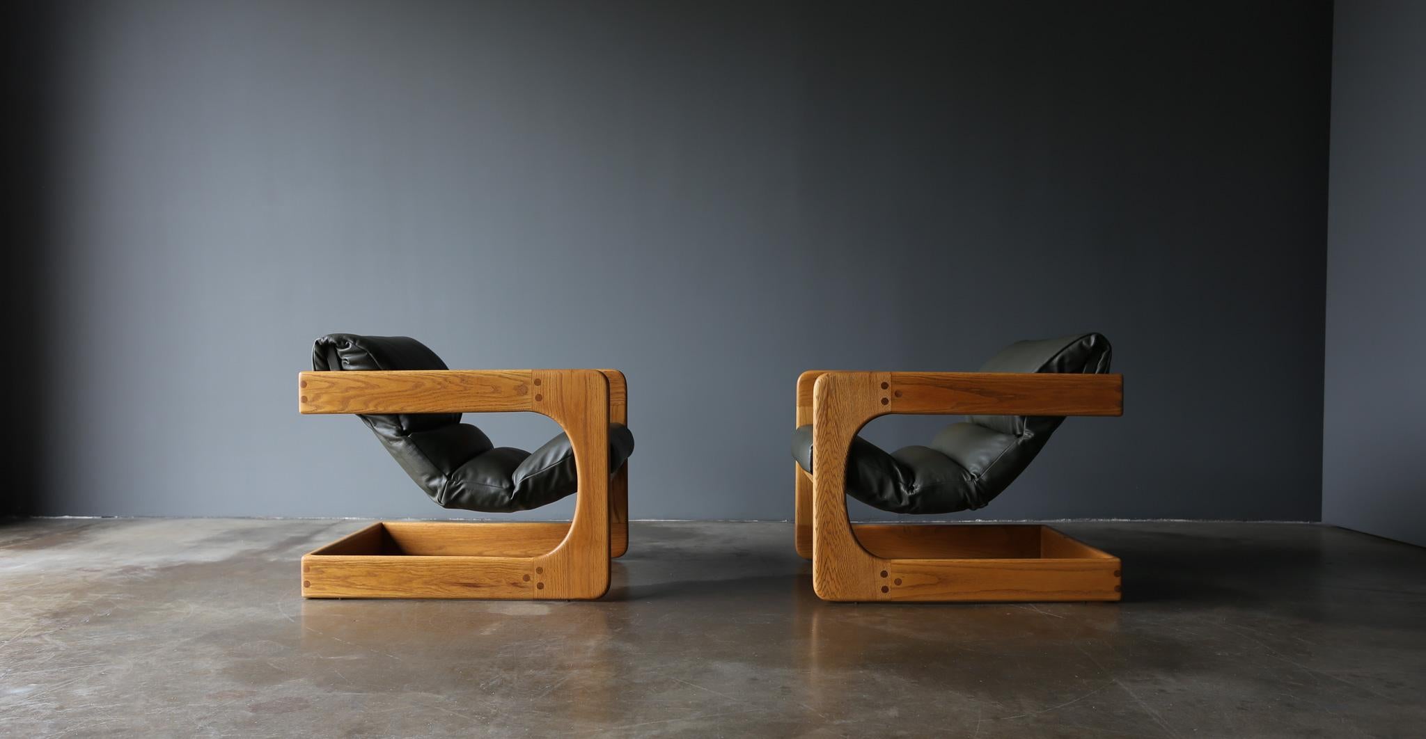 Lou Hodges Oak & Green Leather Lounge Chairs for California Design Group, 1970's.  This pair has been expertly restored.  