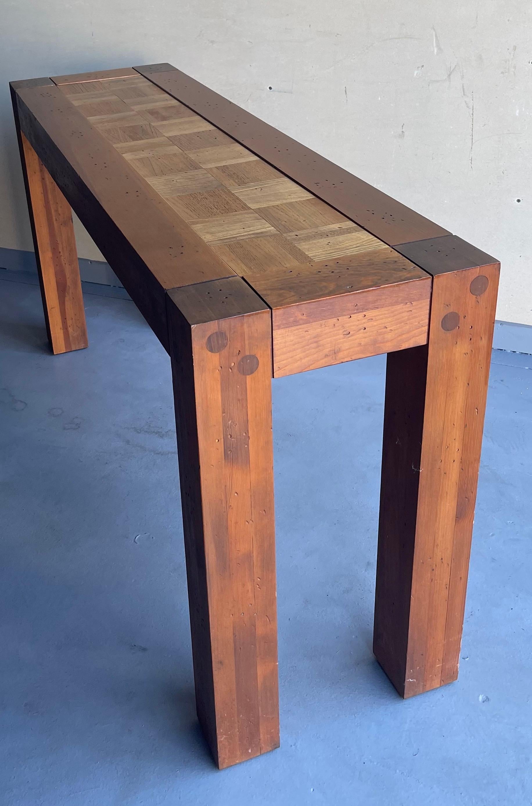 A very cool Lou Hodges style California design walnut and parquet oak console table, circa the 1970s. A beautiful combination of solid oak and walnut frame with a great parquet design. The table is assembled with wood pegs (no nails) and has been