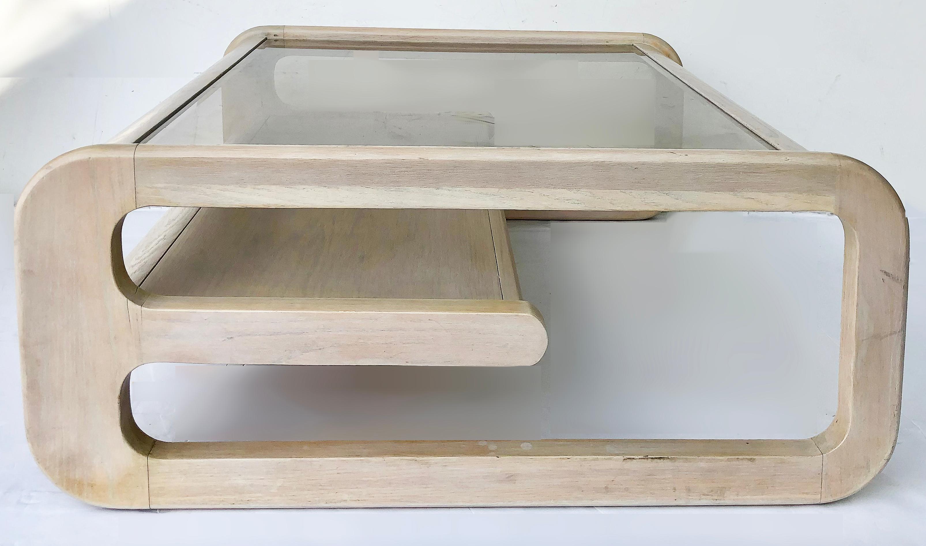 Lou Hodges whitewashed beveled glass coffee table

Offered for sale is a Lou Hodges organic California modern oak coffee or cocktail table that has newly received a whitewash finish. The 1970s 2-tier table has the original inset smoked and beveled
