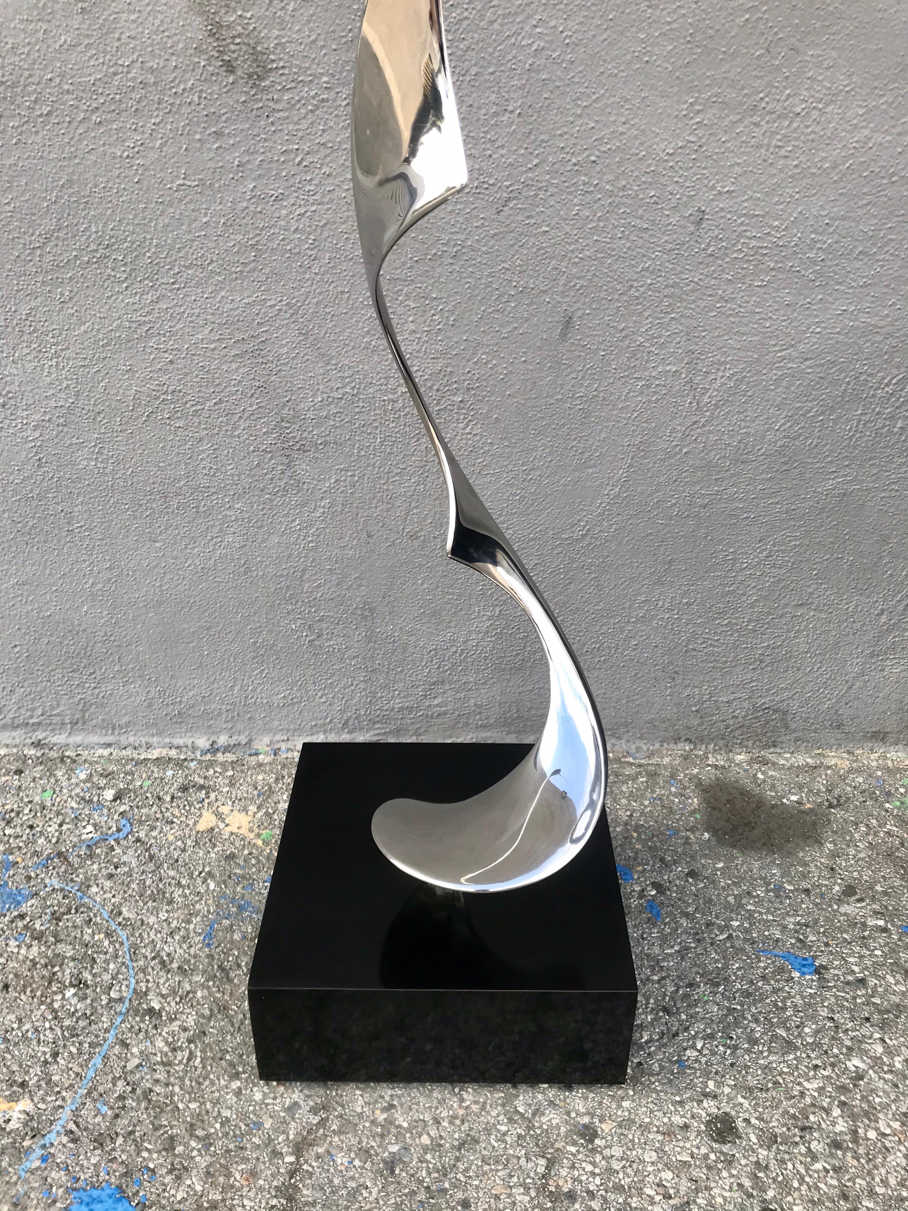 1925 -2005
American artist
elegant piece
polished steel on black laminate pedestal.
        