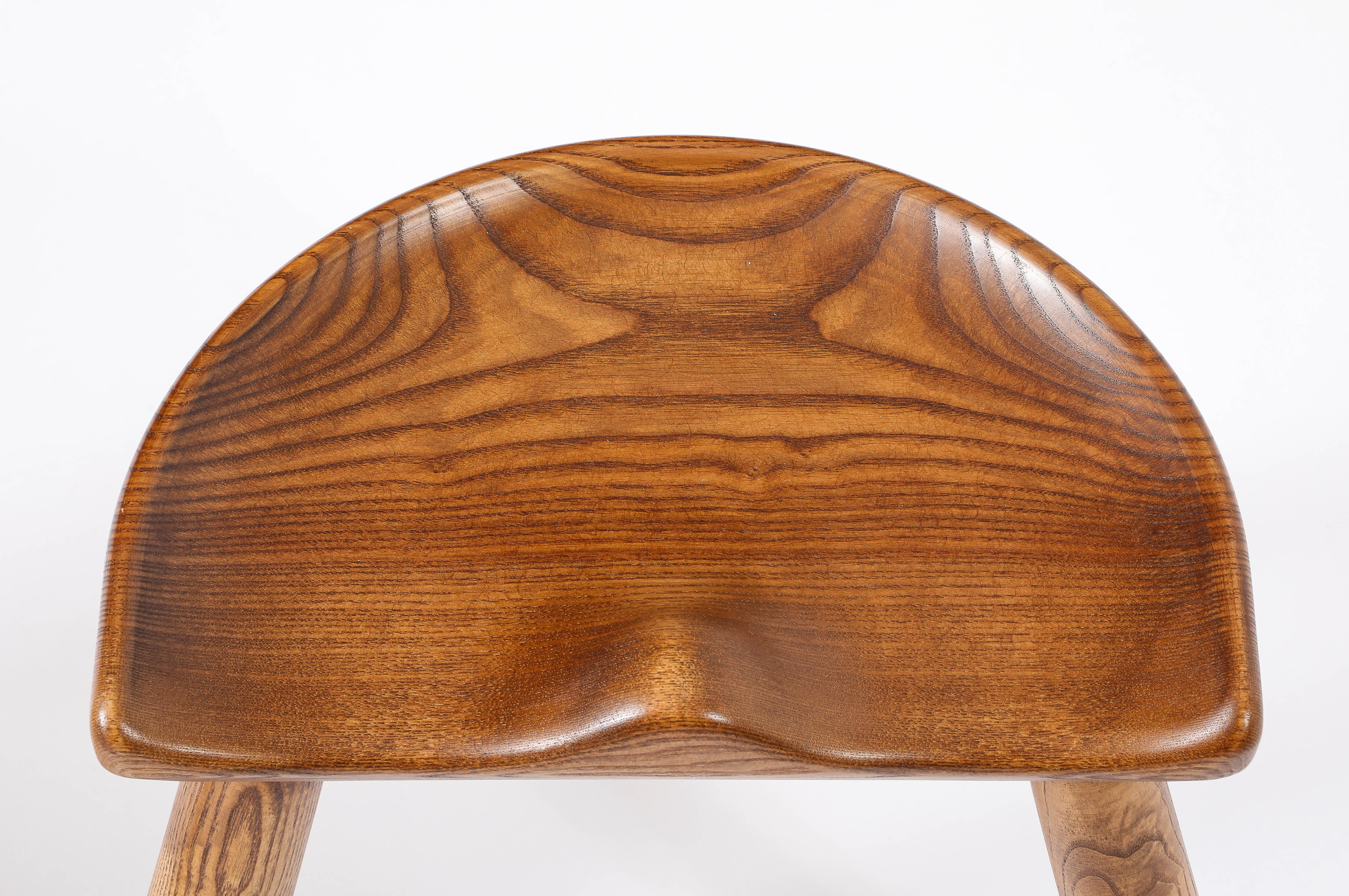 Deeply carved “Tractor” seat stools in oak with a wonderful patina.
