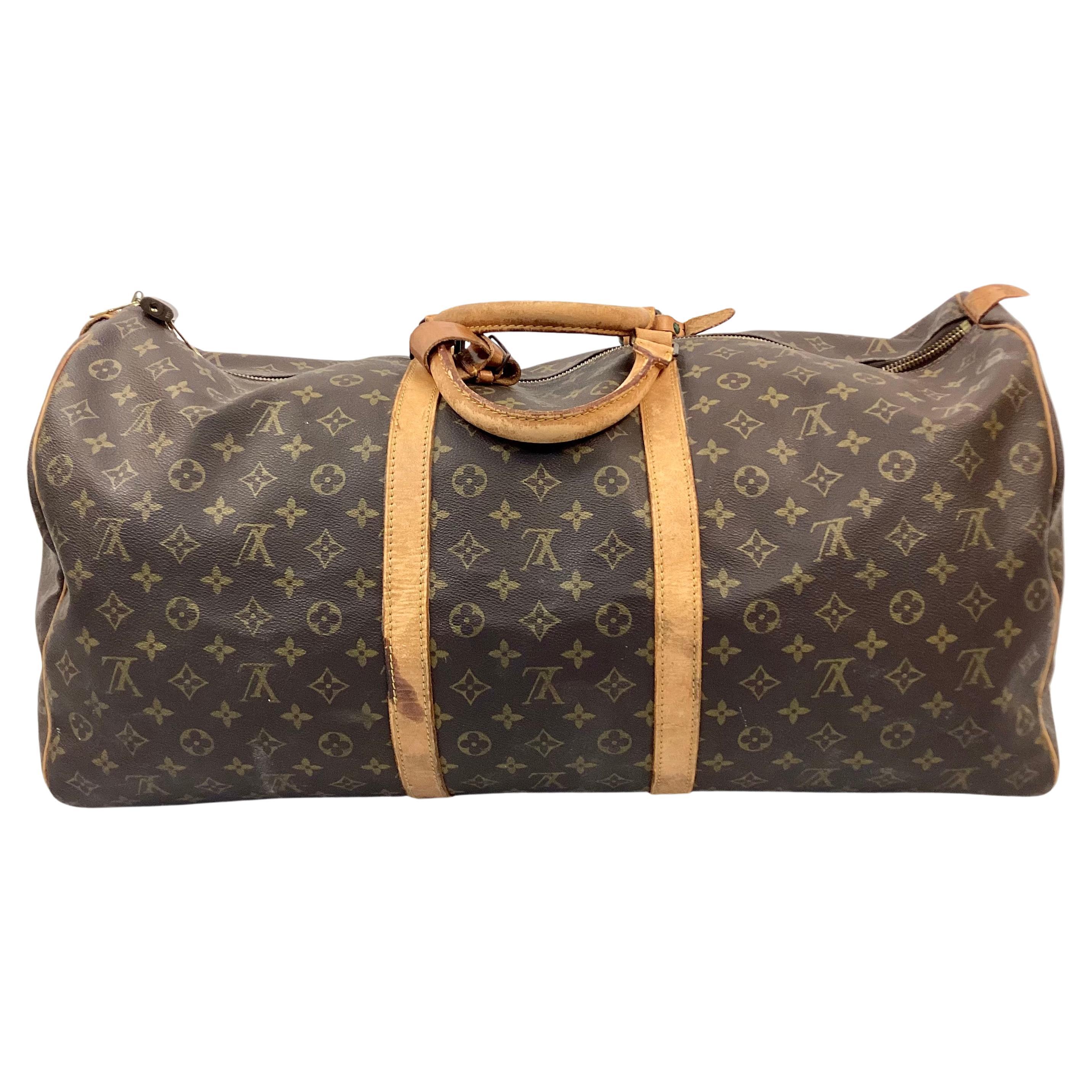 Timeless early 20th century Louis Vuitton Keepall travel Bag in classic monogrammed leather. Gold brass hardware, padlock and leather trim/tag all have the unique Louis Vuitton monogram. No key available.  Has double leather handles, 4.75
