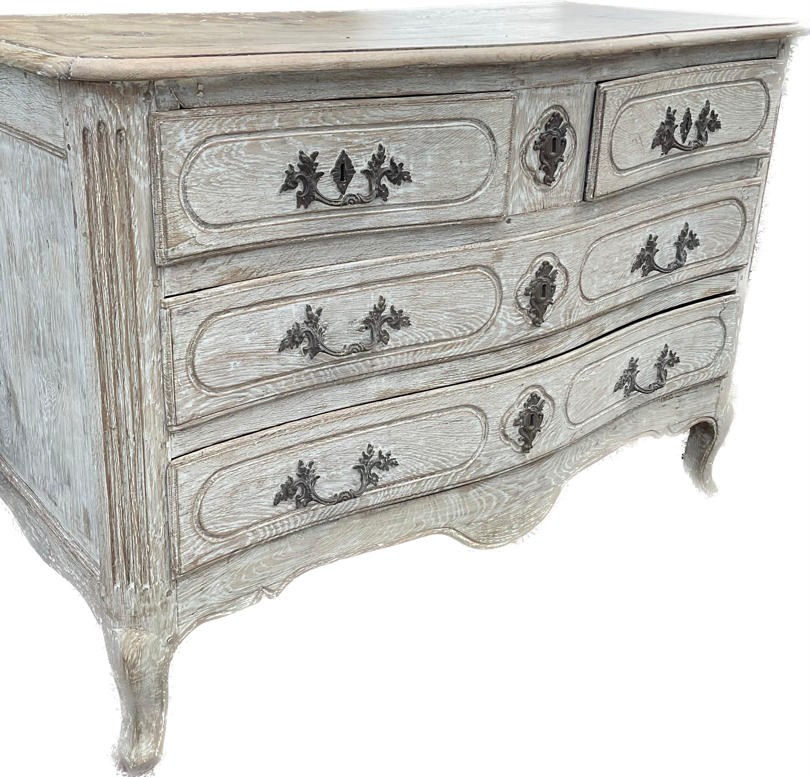 Early 19th century Louis XV chest. Serpentine front with two smaller top drawers and two larger bottom drawers, on sturdy cabriole legs. Chest has a fabulous bleached painted finish in a wonderful old mellow patina with fine brass fittings.