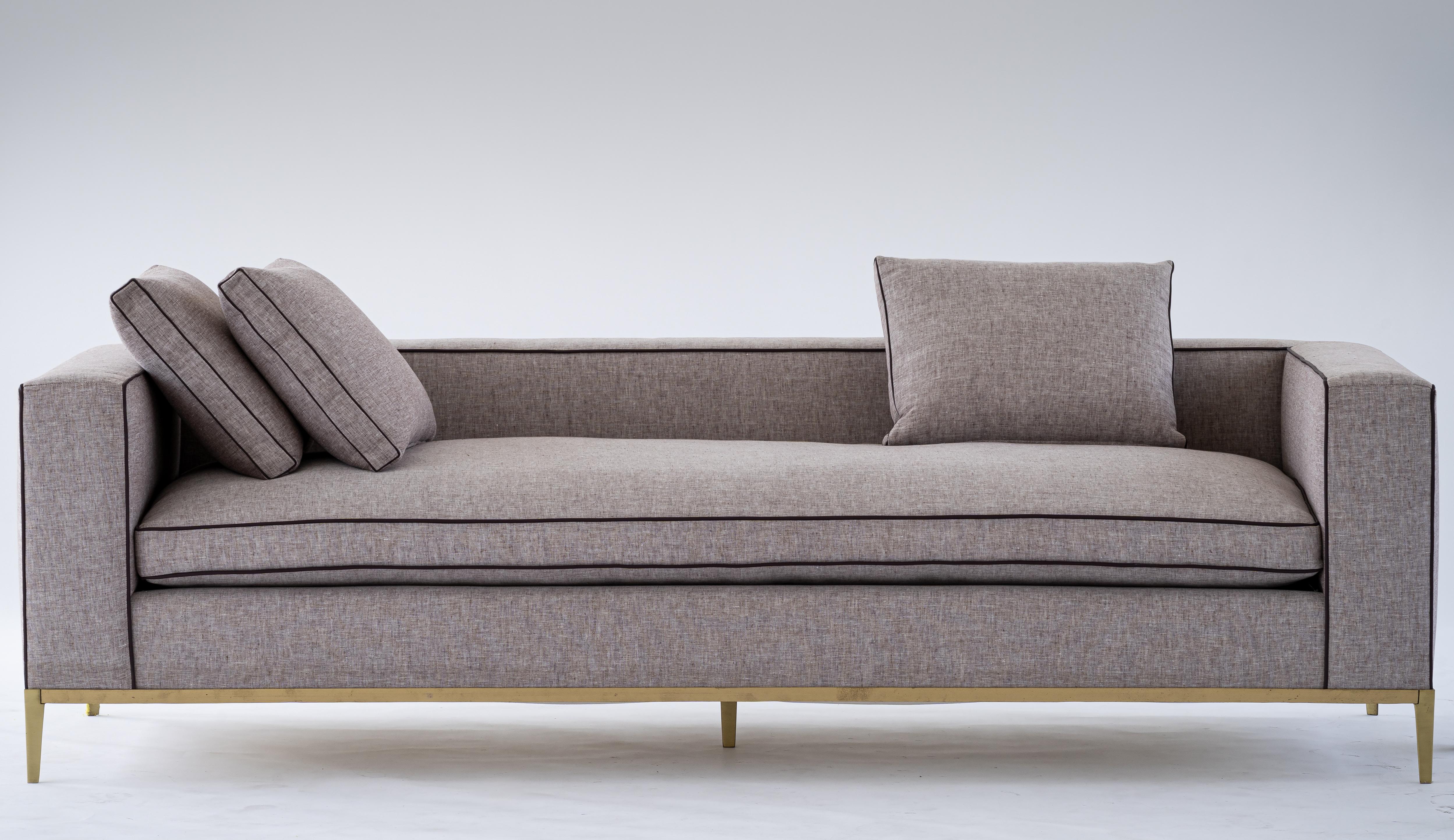 Louis sofa by Mandy Graham

Louis
L06, sofa daybed
Shown in, brushed brass plum linen chambray by C & C Milano with contrast leather pipe
cut in detail on the join between arm/back
5 box pillows (3 large, 2 small)
1 loose, down filled seat