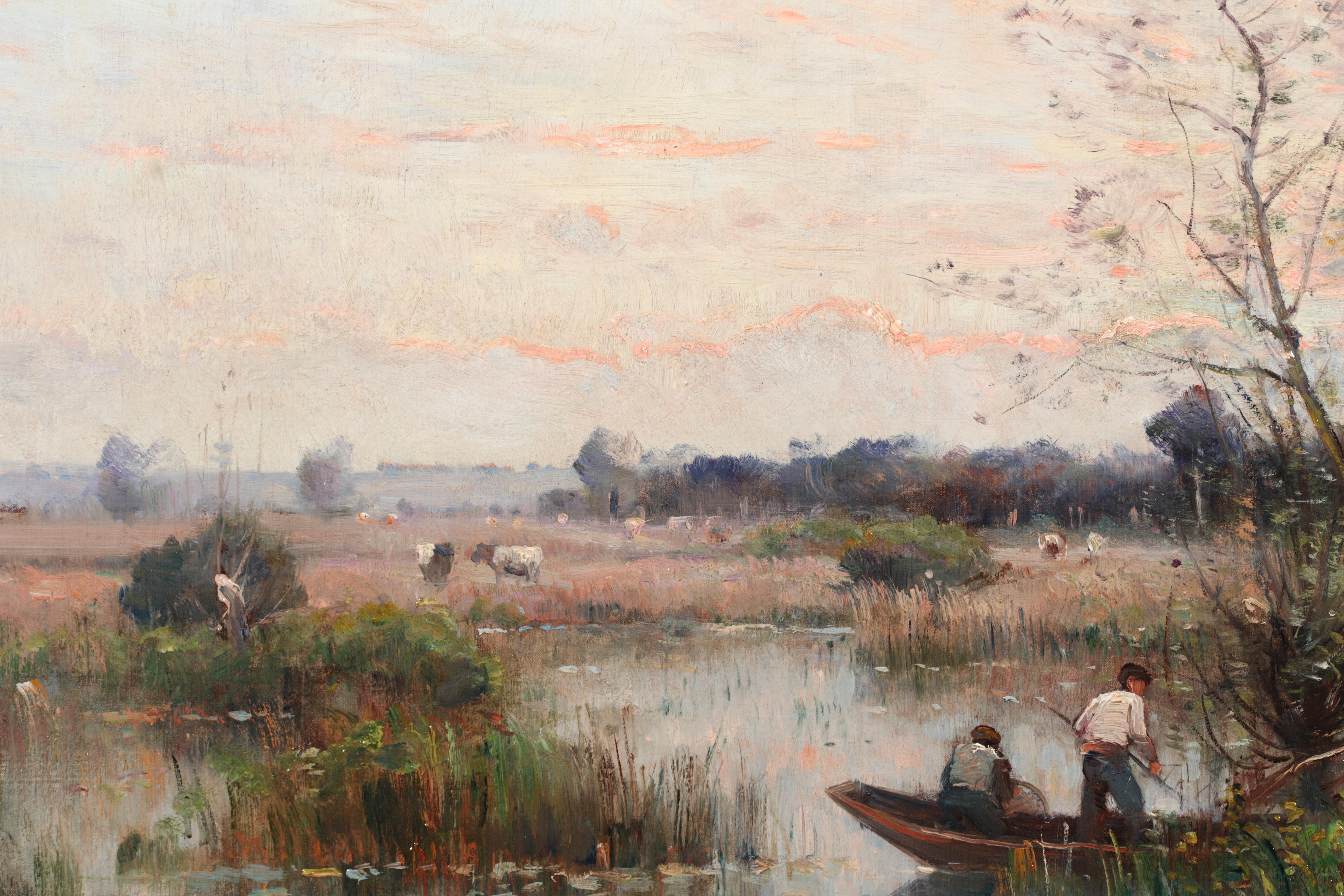 Signed and dated riverscape oil on canvas by French impressionist painter Louis Aime Japy. The work depicts two fisherman in a small punt in a river at sunset. The clouds in the sky are glowing pink by the fading sun and below cattle are grazing in