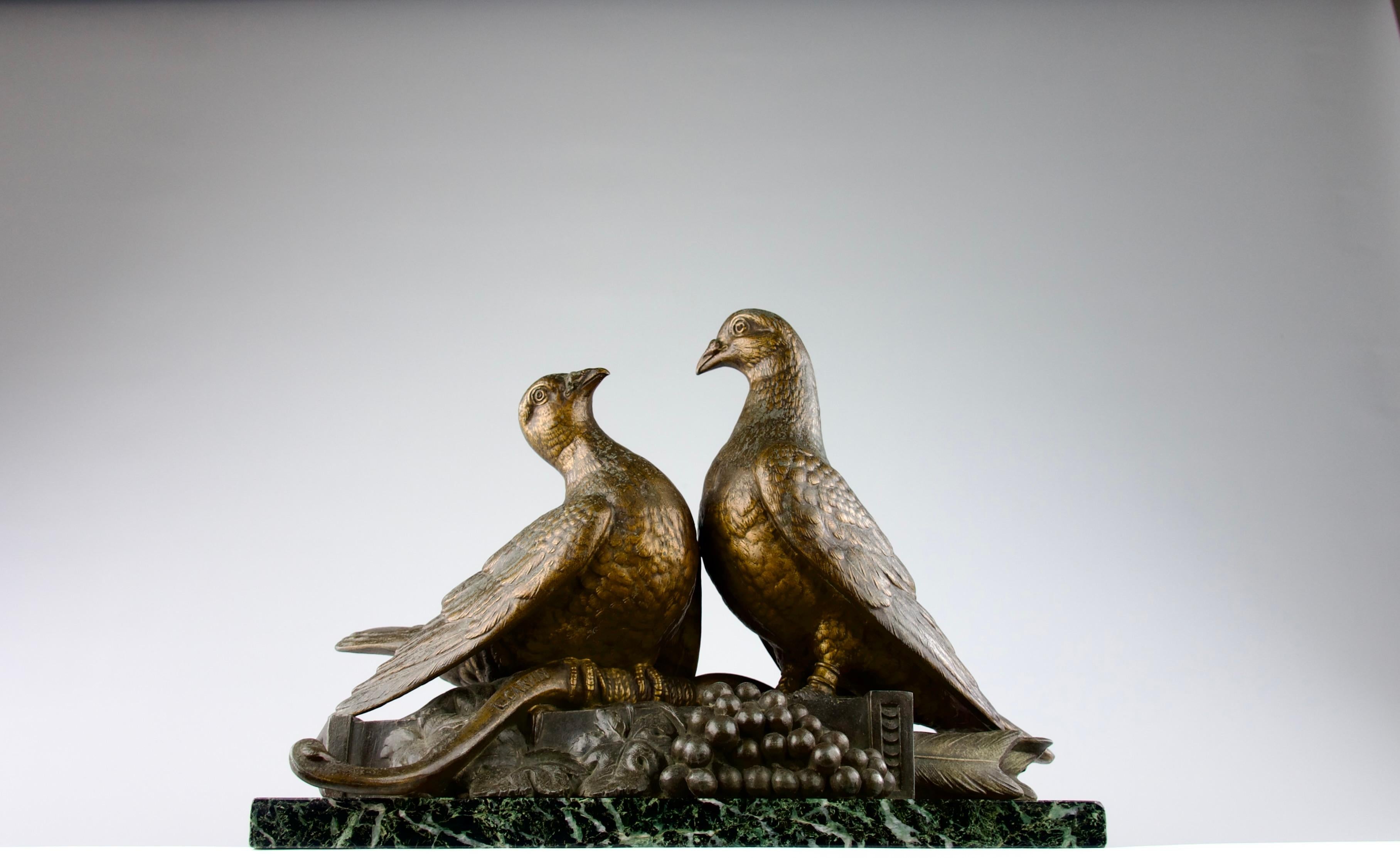 Beautiful romantic Art Deco spelter sculpture by Louis Albert Carvin (1875-1951) of two lovebirds standing atop some grapes and a quiver filled with arrows, symbols of the bacchanales of Dionysus and Cupid, facing one another and forming a heart