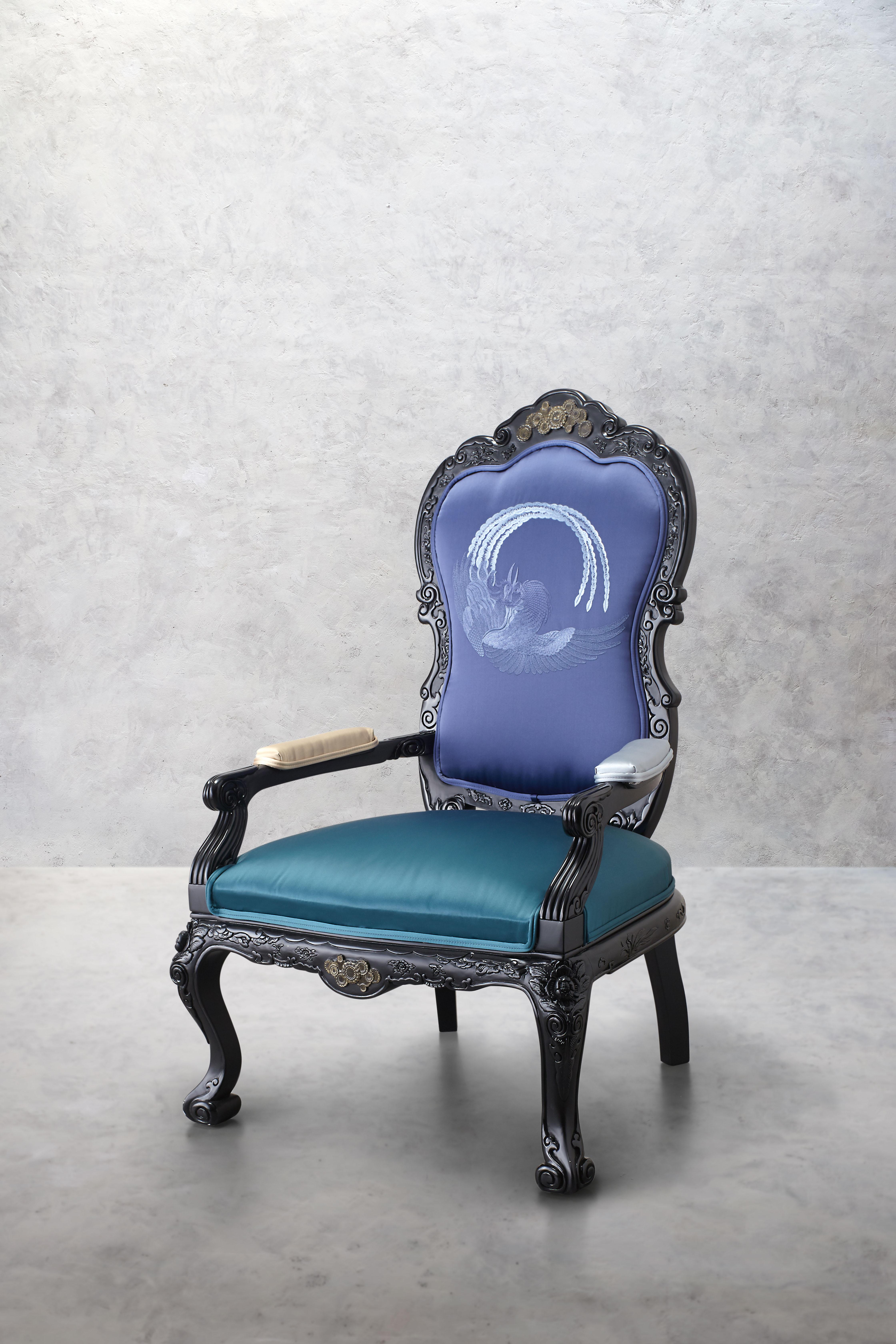 This armchair has a sumptuous design, upholstered with an eclectic combination of four distinct satin fabrics, making it a charming statement piece for modern living spaces. The solid beech structure is enriched with hand-carved details, finished