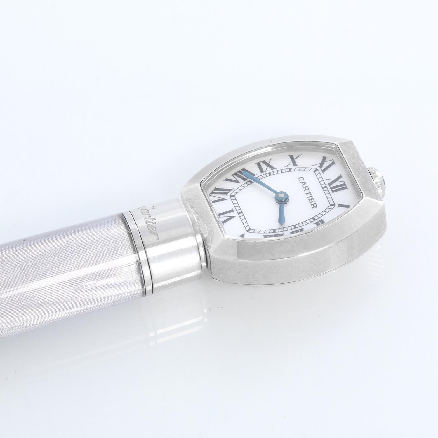 Louis Cartier “guilloche” Mother Of Pearl Ballpoint Pen - Ballpoint pen with watch and guilloche processing. Stainless steel pen with quartz watch assembly, mother-of-pearl dial, and black Roman numerals. Black ink. Length: 12. 9 cm. Limited edition