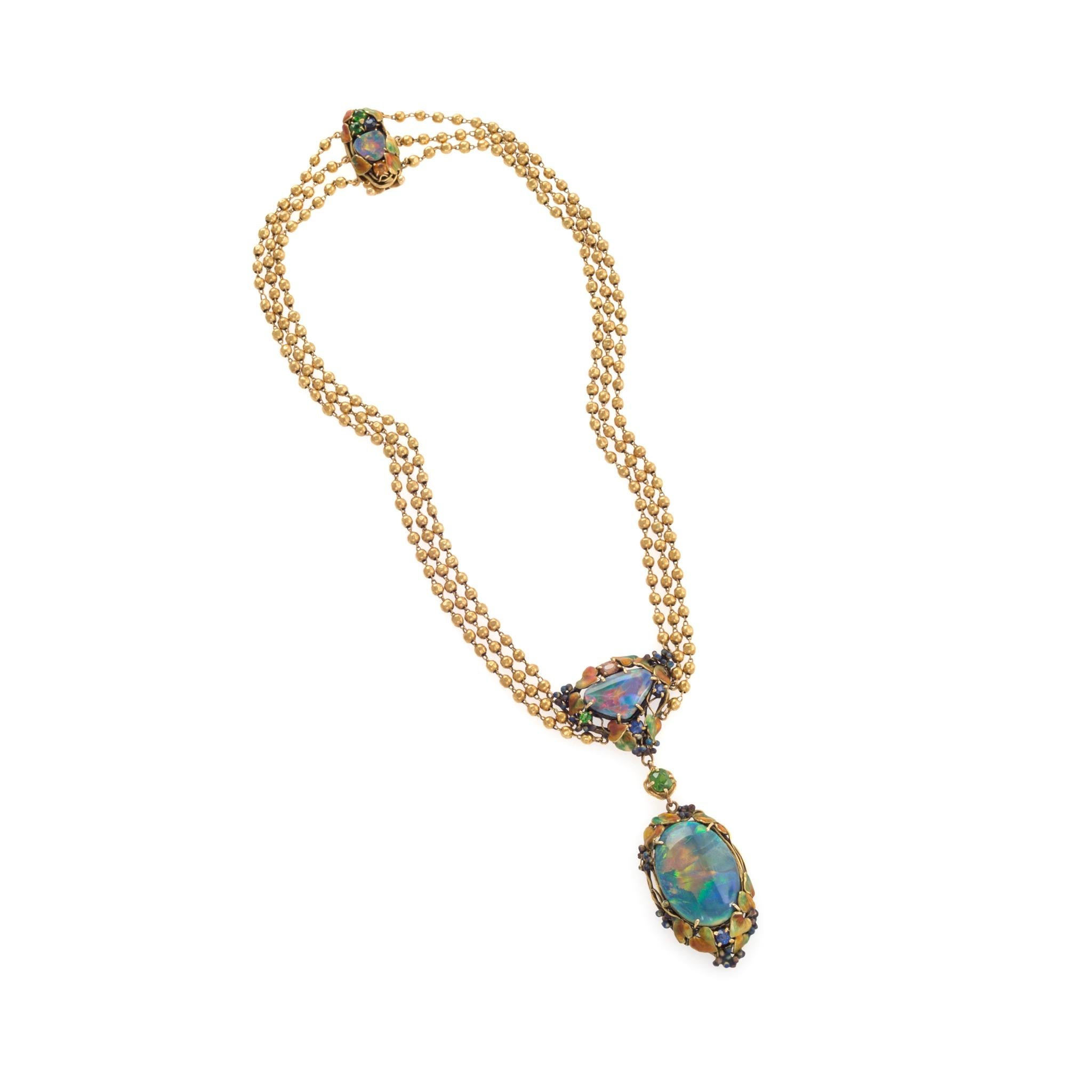 Louis Comfort Tiffany played with the unusual light and color effects of black opals, green garnets, and sapphires to create an impressionistic artwork in this visually intriguing Tiffany & Co. necklace and bracelet set. The opals, with their