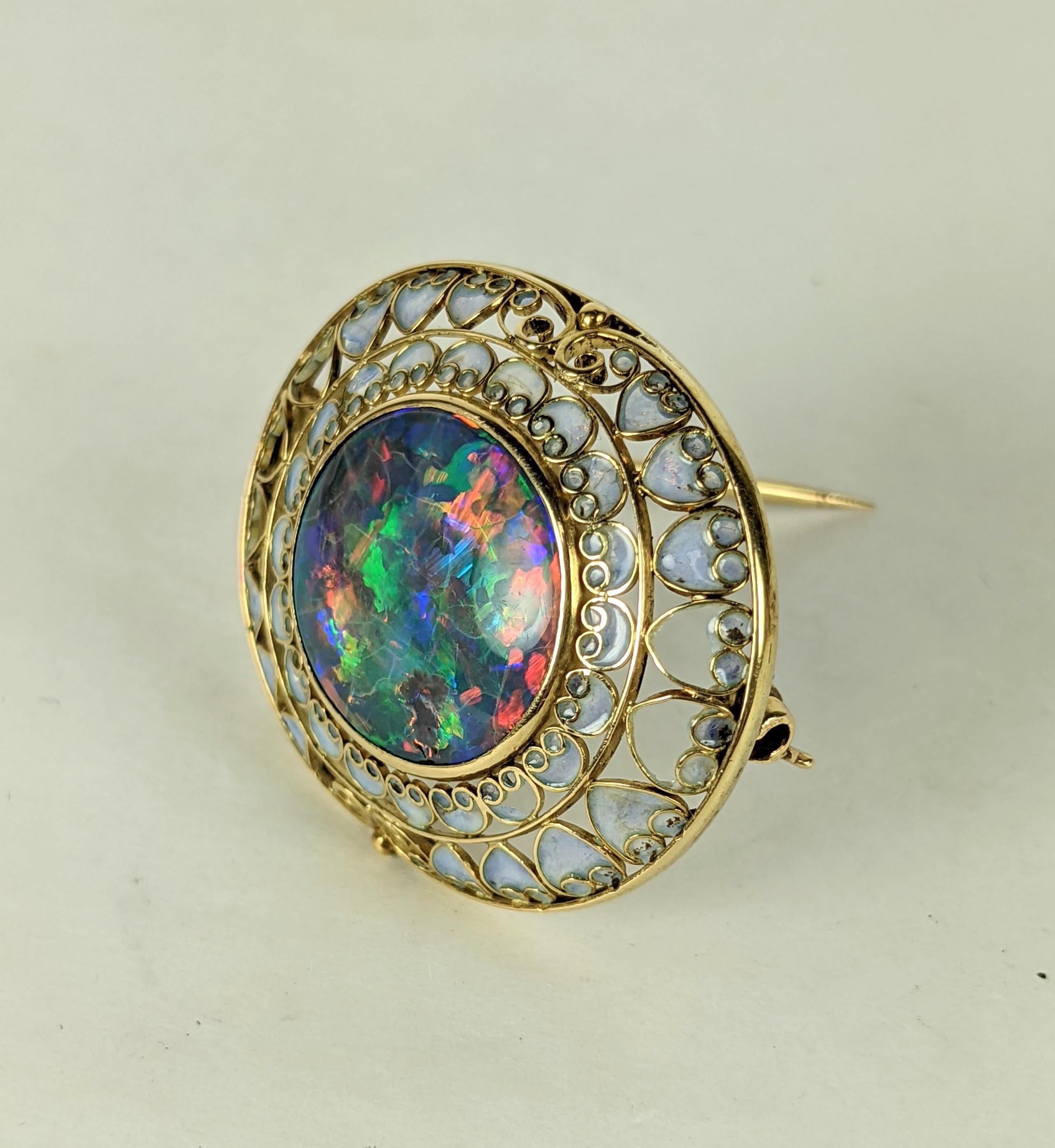 Tiffany Arts and Crafts Era Black Opal and Plique a Jour Brooch circa 1910's by Louis Comfort Tiffany with Julia Munson in 18k gold. Large peacock Black Opal round measuring .75