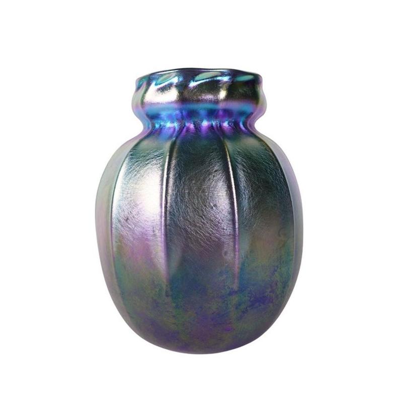 Offering this outstanding, Louis Comfort Tiffany blue Favrile iridescent art glass vase. This vase features a bulbous ribbed body with a cinched neck and mouth design. Signed on the underneath 