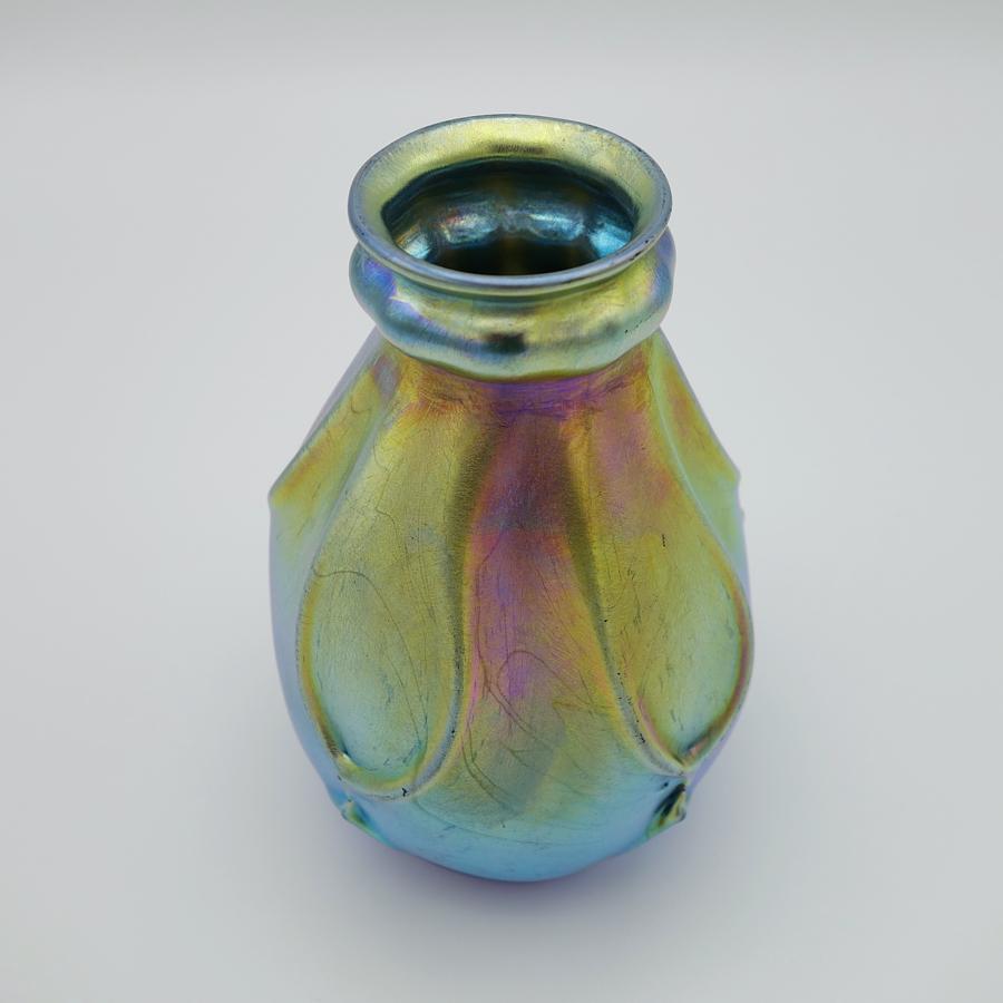 Offering this outstanding, decorated Louis Comfort Tiffany blue Favrile iridescent art glass vase. This vase features a bulbous body with double cinched neck and mouth design decorated all over with pulled glass. Signed on the underneath 
