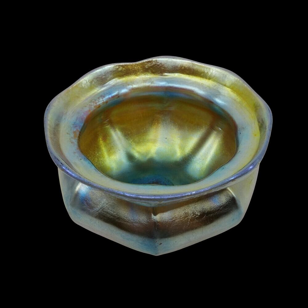 Offering this diminutive Louis Comfort Tiffany gold Favrile iridescent art glass vase. This vase features a six-ribbed cinched body with a flared mouth in rare dark amber glass. Signed on the underneath 